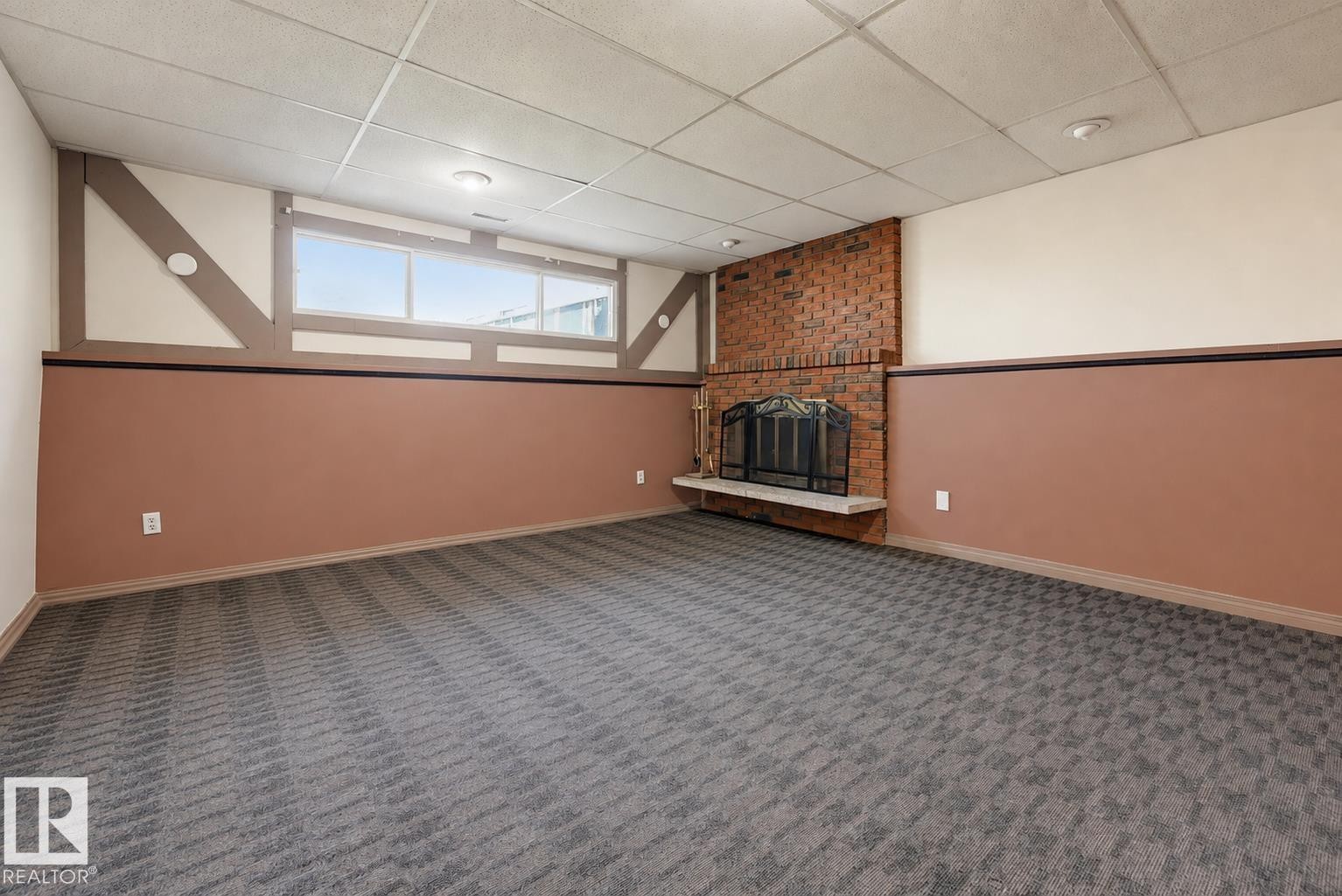 Recessed lighting, drop ceiling, brick fireplace, concrete hearth, and patterned carpeting - 6768 39 Avenue Nw, Edmonton, AB - Indoor