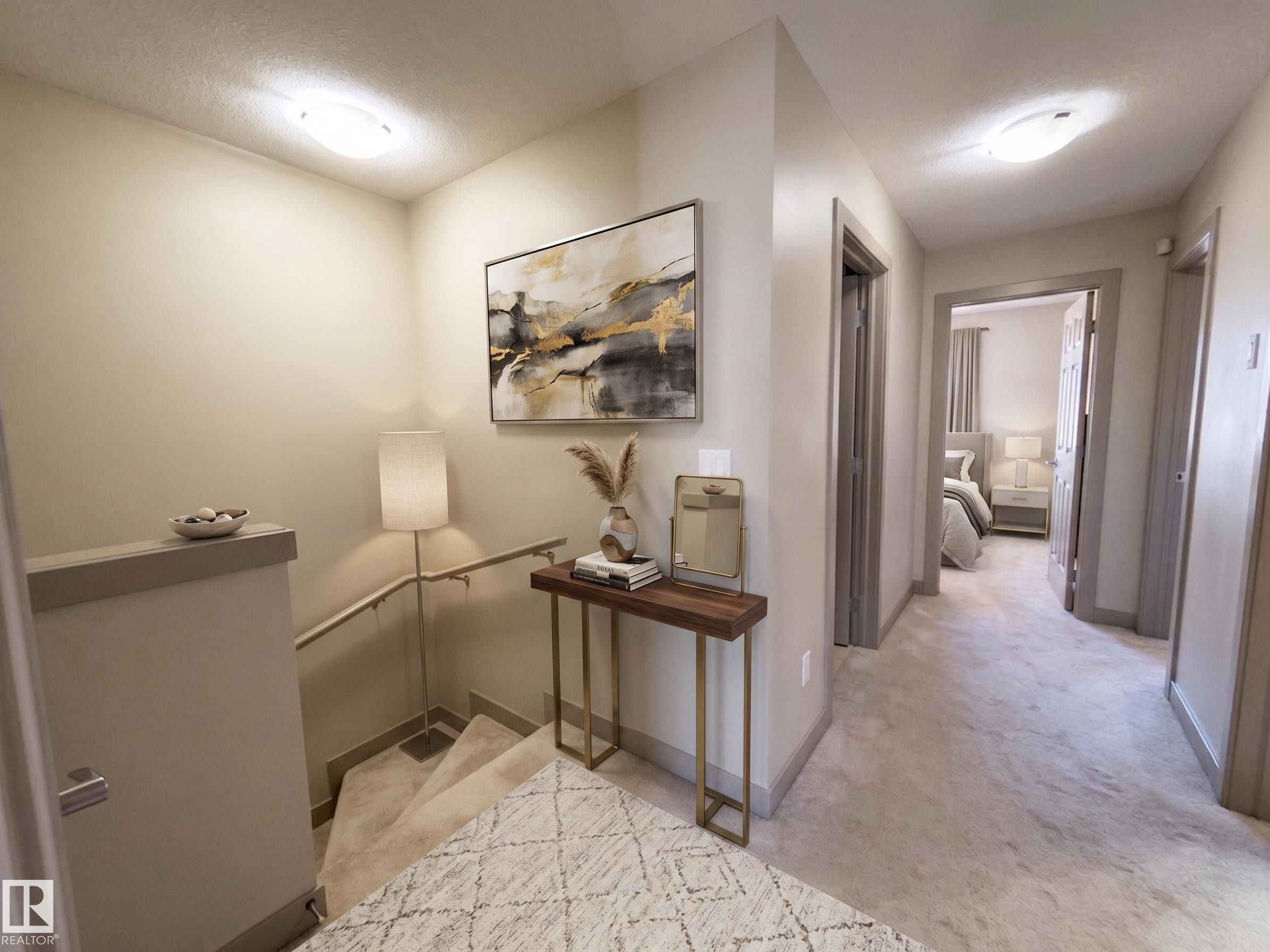 Carpeted hallway and staircase with light walls and flush-mount lighting fixtures - #29 1150 Windermere Wy Sw, Edmonton, AB