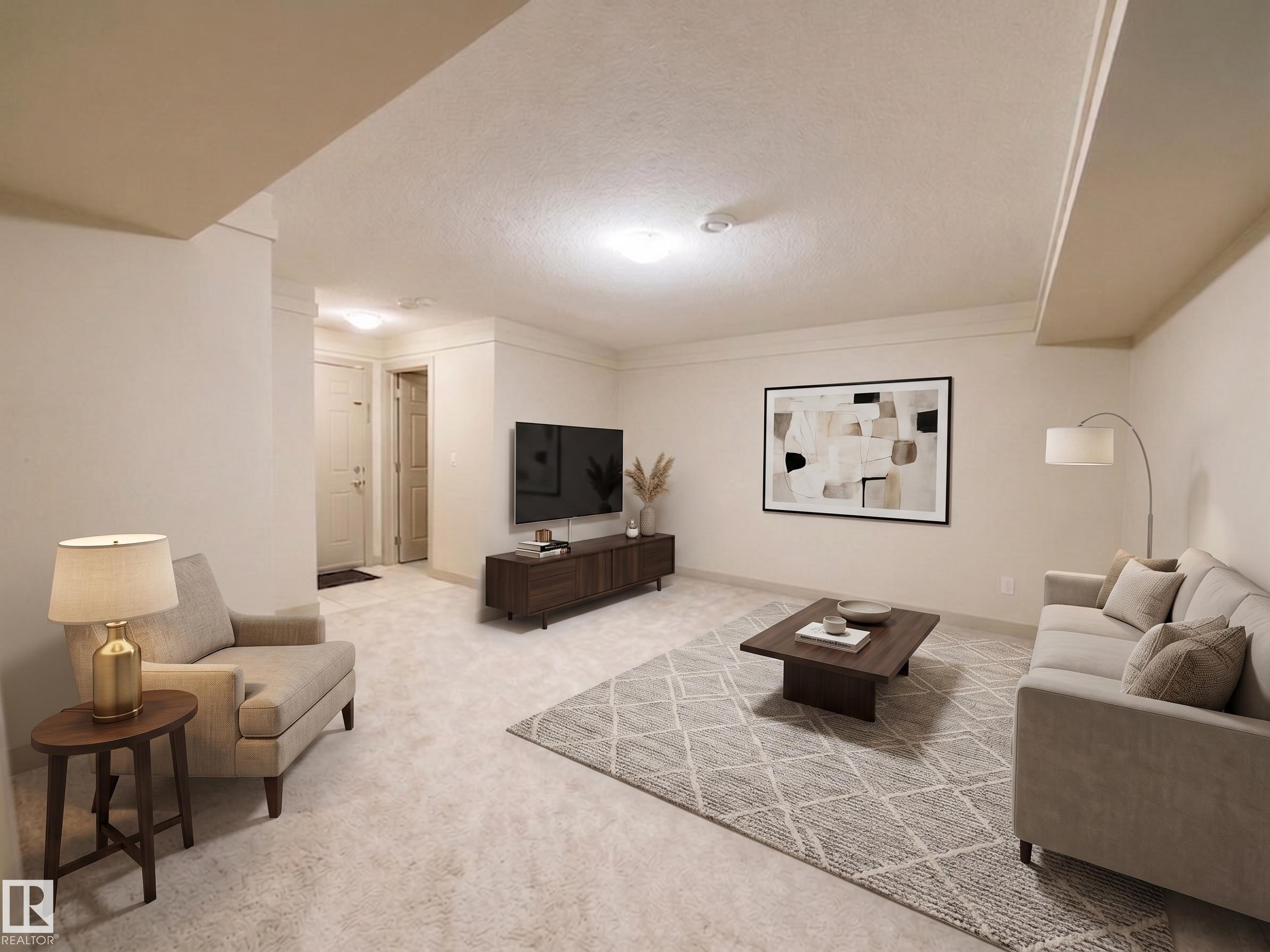 Recessed lighting illuminates the carpeted living area with light-toned walls - #29 1150 Windermere Wy Sw, Edmonton, AB