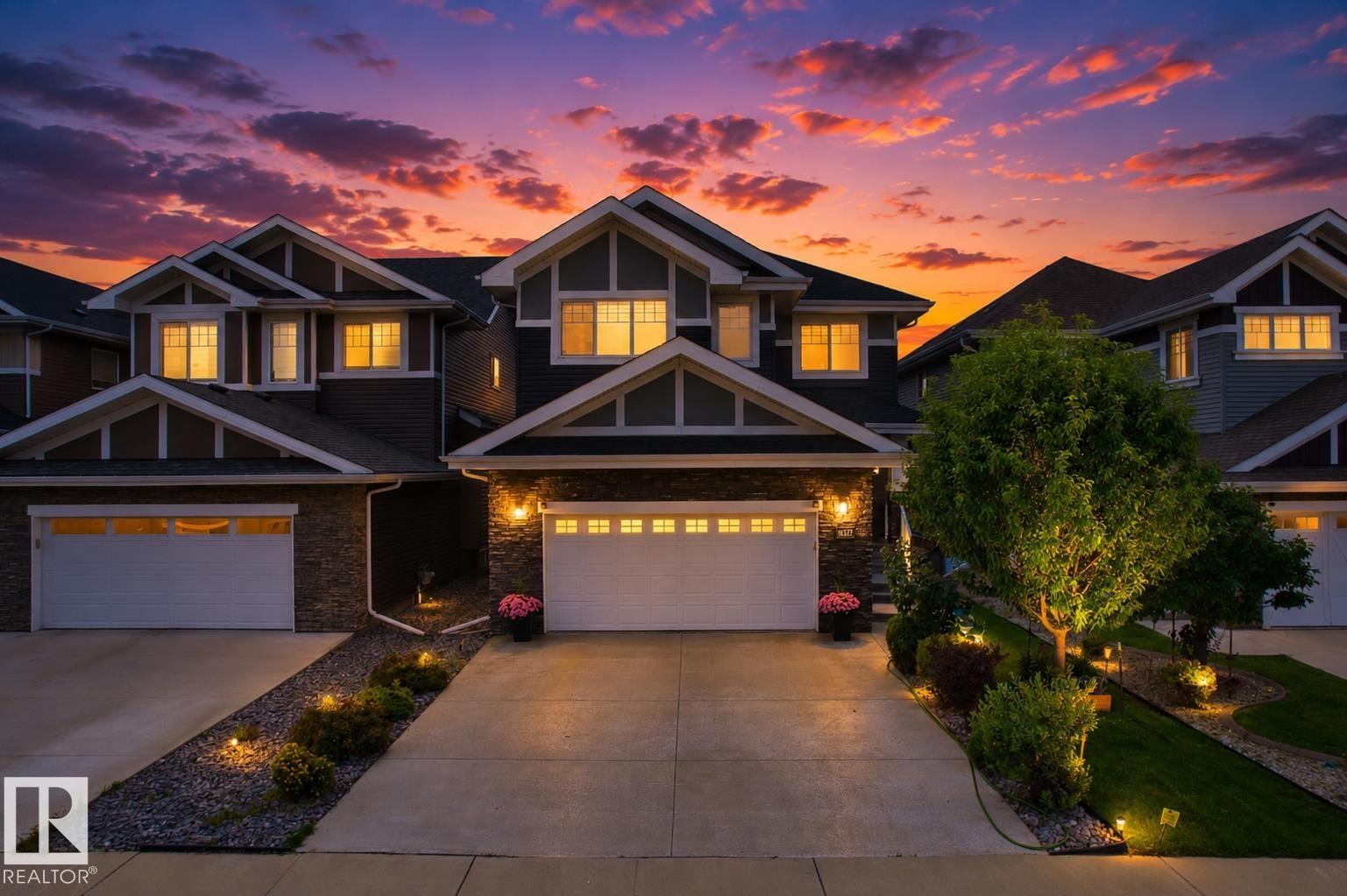 Craftsman-style exterior with stone and siding accents, dual garage doors, and a concrete driveway - 16327 17 Avenue Sw, Edmonton, AB - Outdoor With Facade