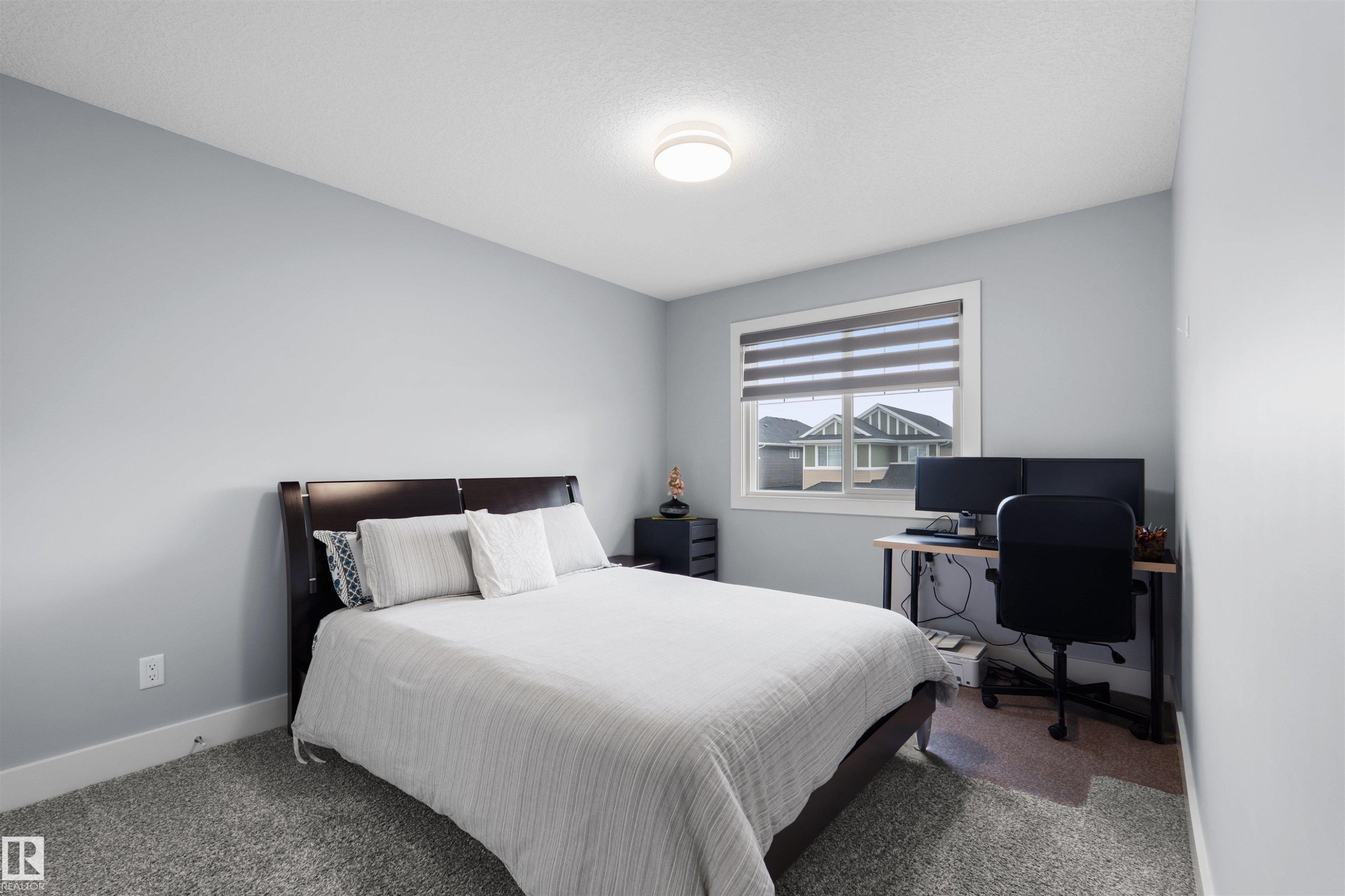 Light gray wall color, textured ceiling, flush mount ceiling light, white window trim, grey window blinds - 16327 17 Avenue Sw, Edmonton, AB - Indoor Photo Showing Bedroom