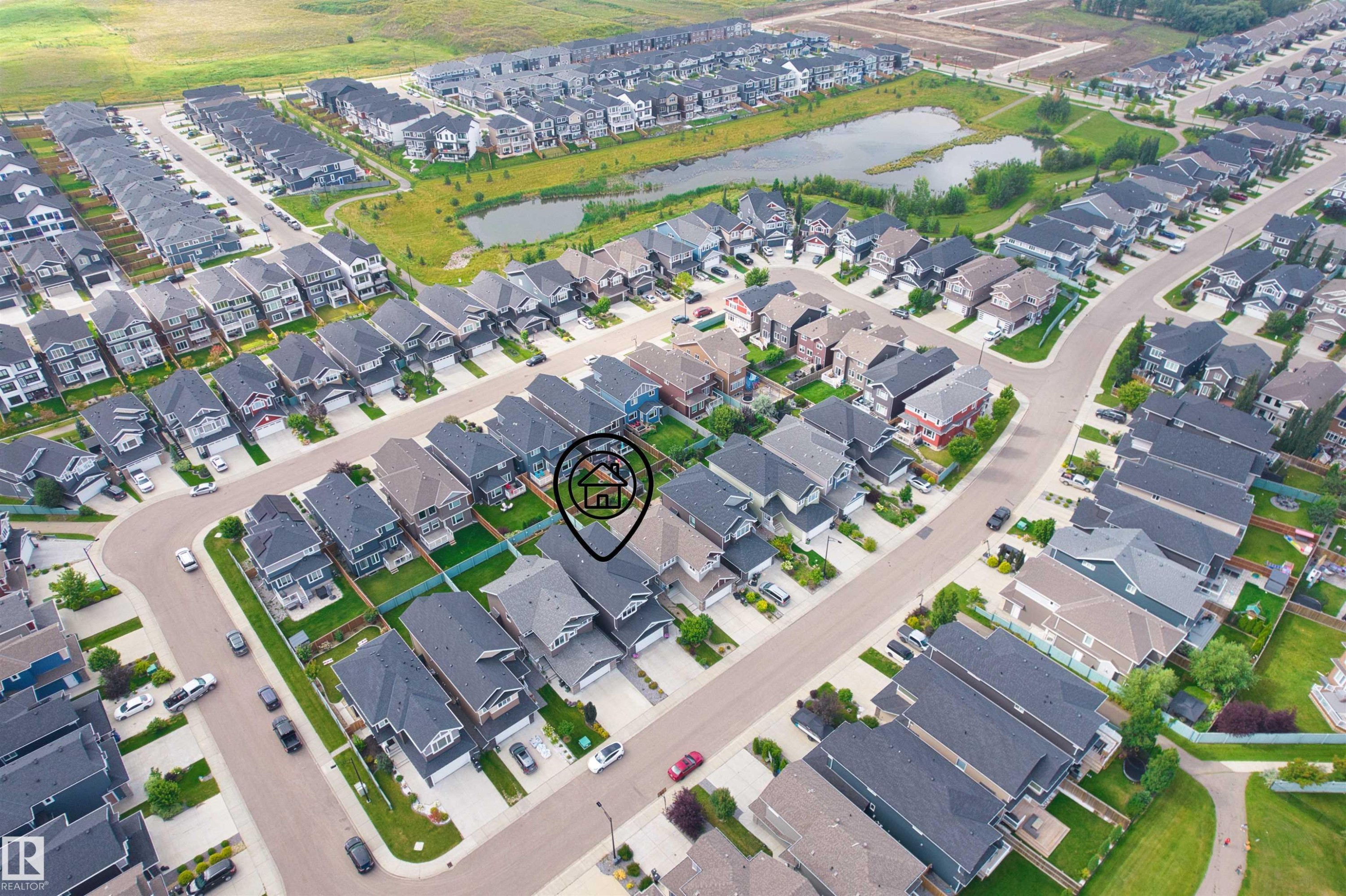 Aerial neighborhood perspective with residential streets, multiple properties, and a prominent body of water - 16327 17 Avenue Sw, Edmonton, AB - Other