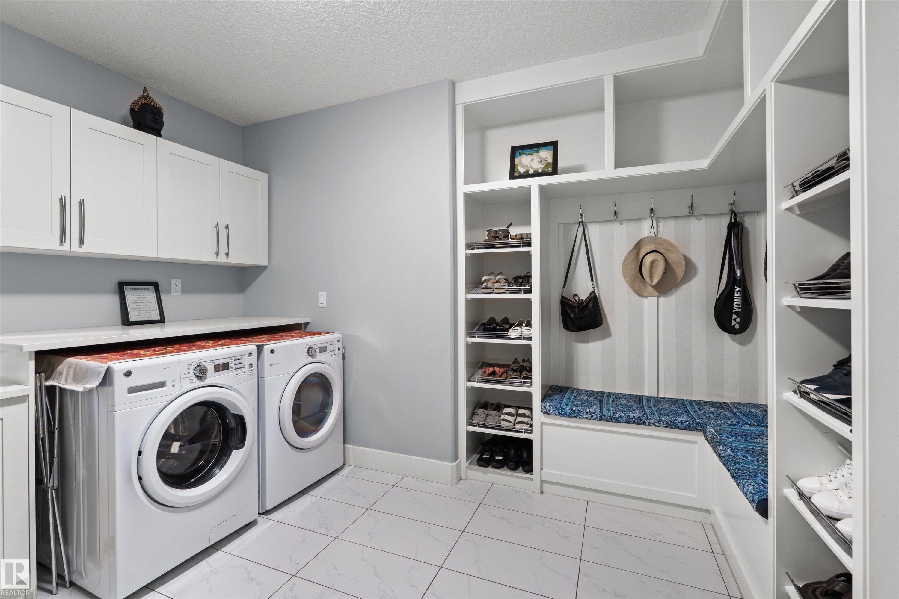 Laundry area with built-in storage, white upper cabinetry, and a countertop - 16327 17 Avenue Sw, Edmonton, AB - Indoor Photo Showing Laundry Room
