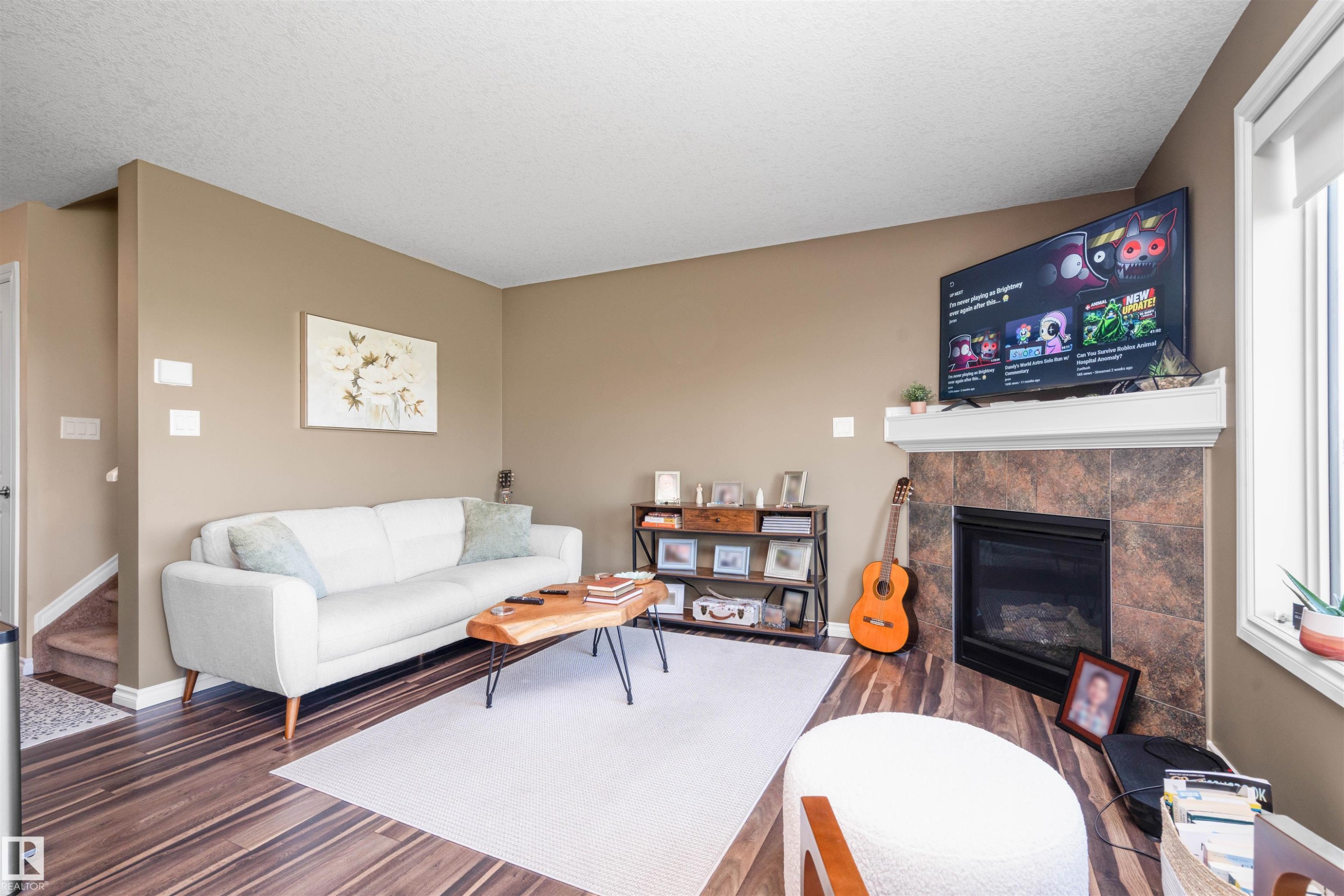 #146 5420 Grant Macewan Bv, Leduc, AB - Indoor Photo Showing Living Room With Fireplace