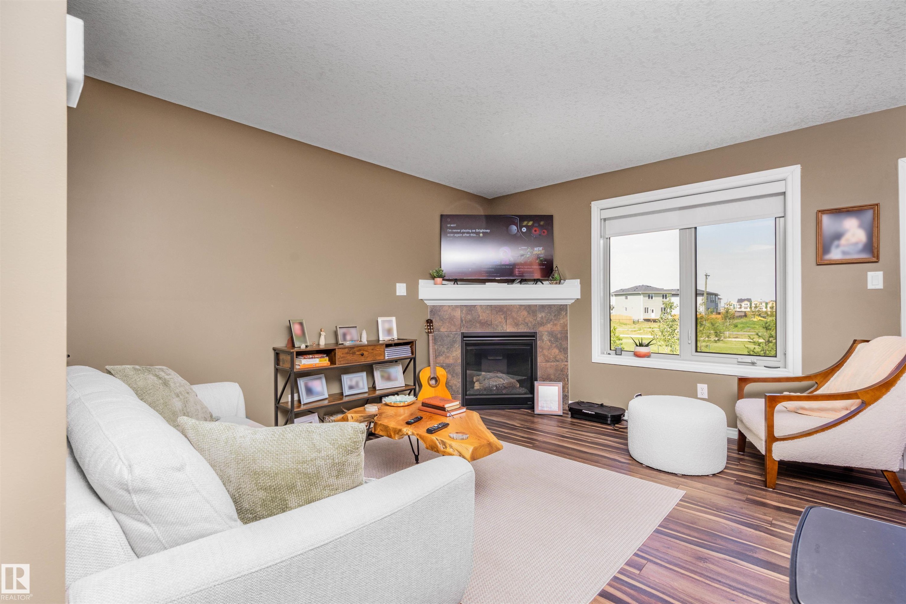 #146 5420 Grant Macewan Bv, Leduc, AB - Indoor Photo Showing Living Room With Fireplace