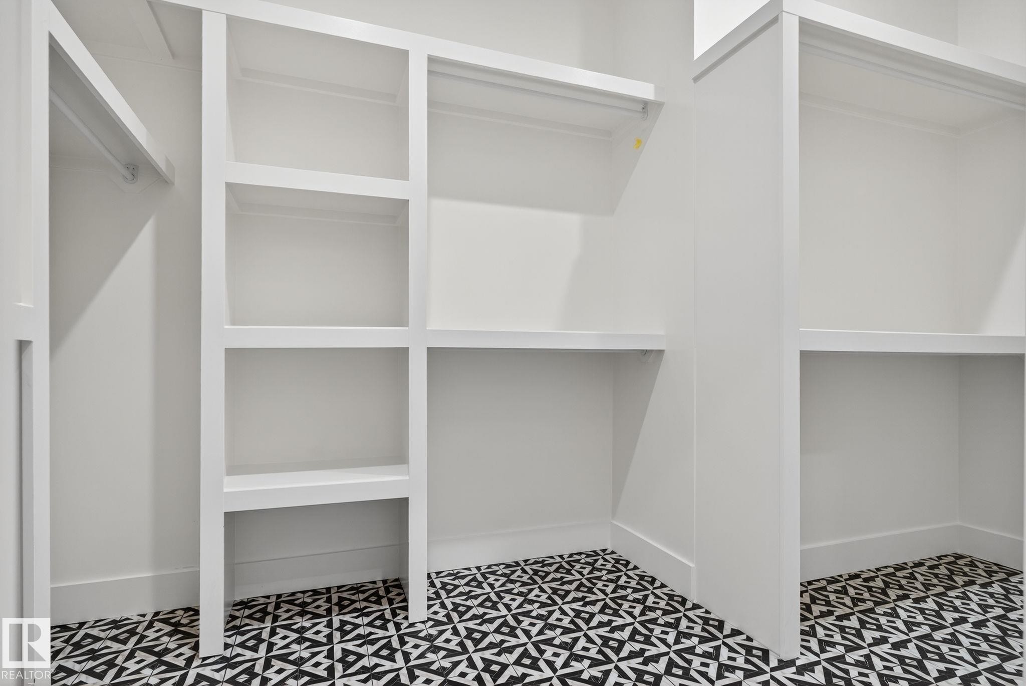 Built-in shelving units, integrated hanging rods, and patterned floor tile - 9736 73 Avenue Nw, Edmonton, AB