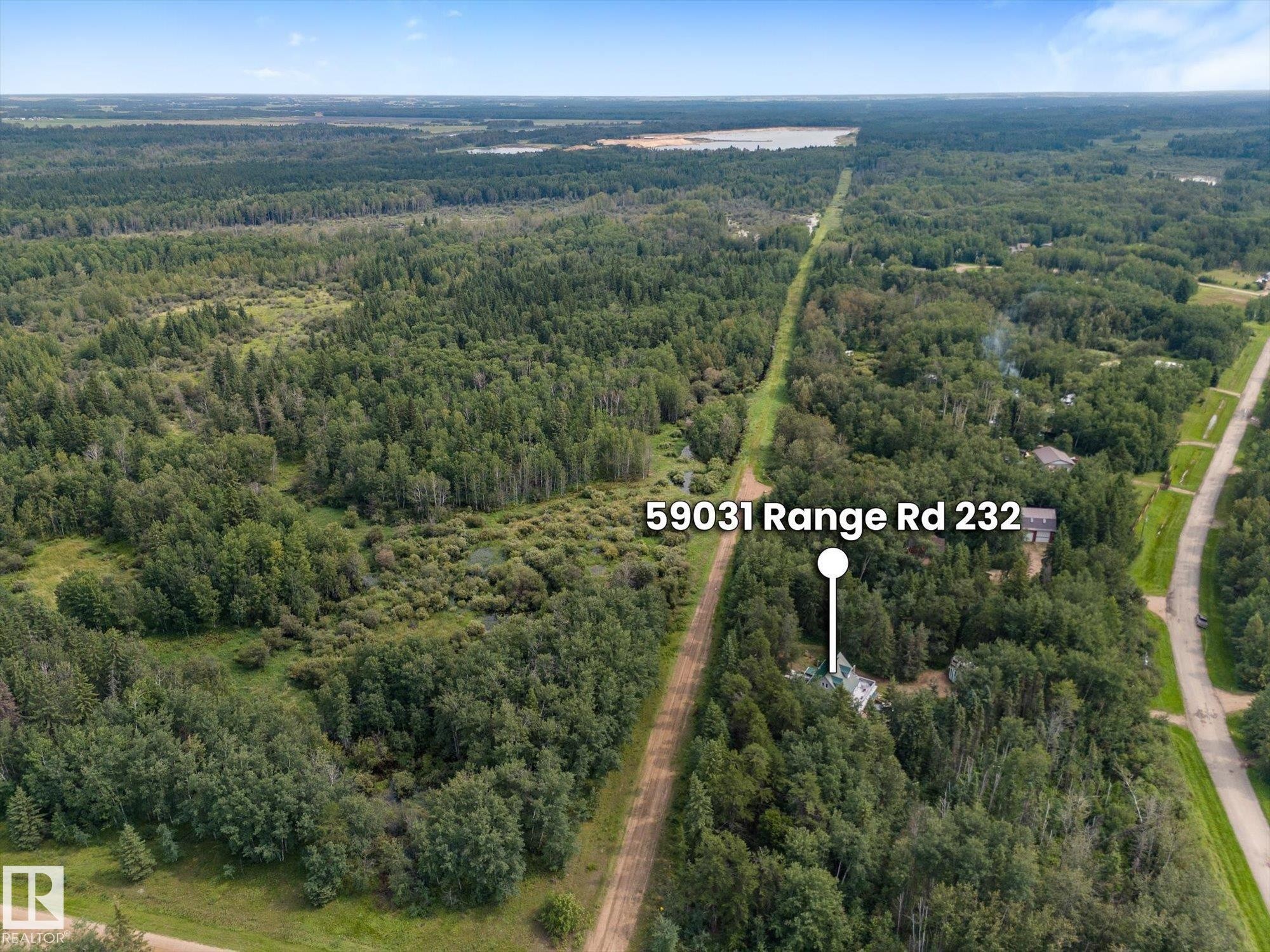 Expansive wooded property with a visible structure surrounded by mature trees - 2, 59031 Range Rd 232, Rural Thorhild County, AB - Outdoor With View