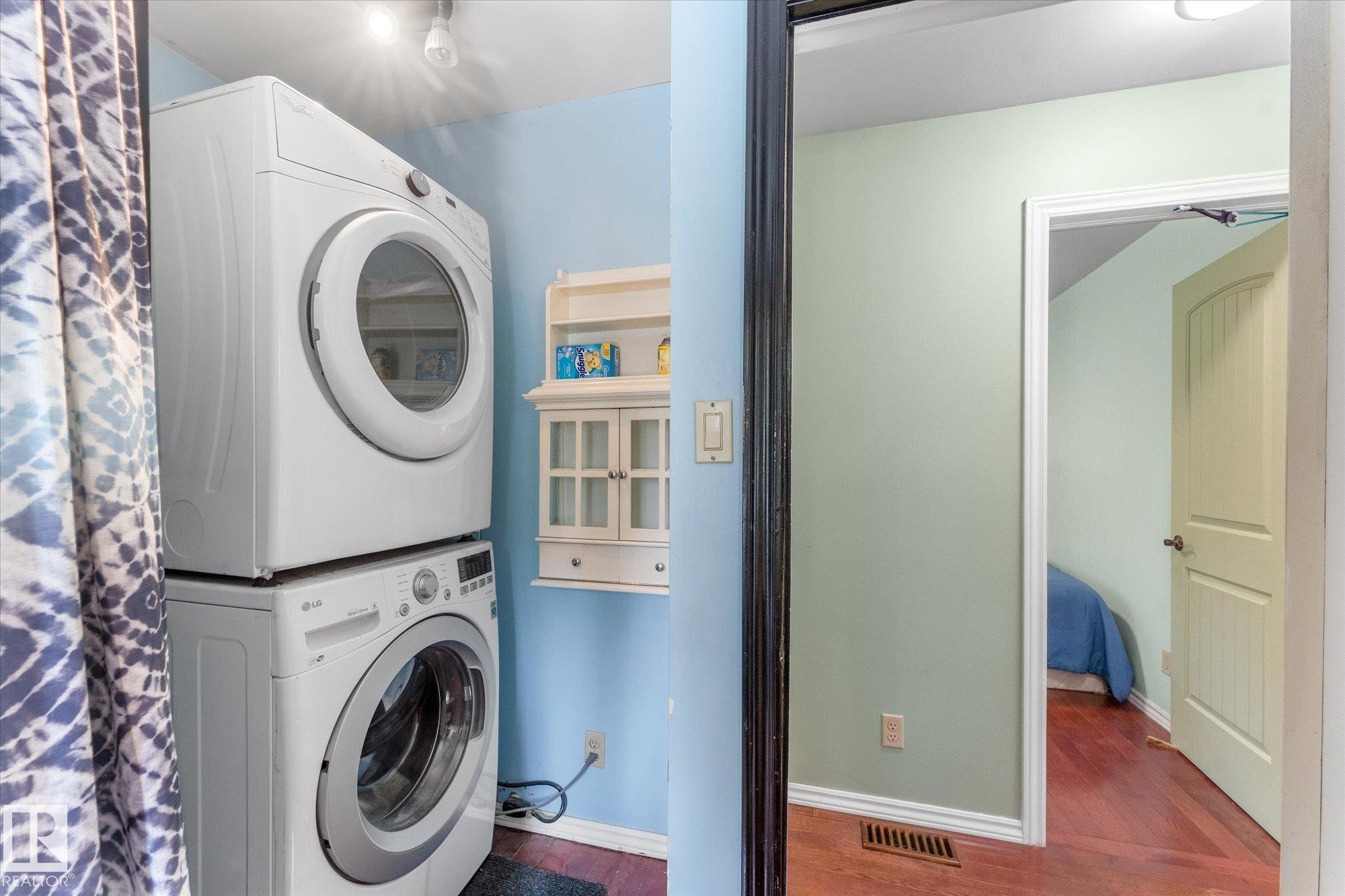 Stackable laundry appliances with a front-load washer and dryer so convenience in main bath on the main floor - 2, 59031 Range Rd 232, Rural Thorhild County, AB - Indoor Photo Showing Laundry Room