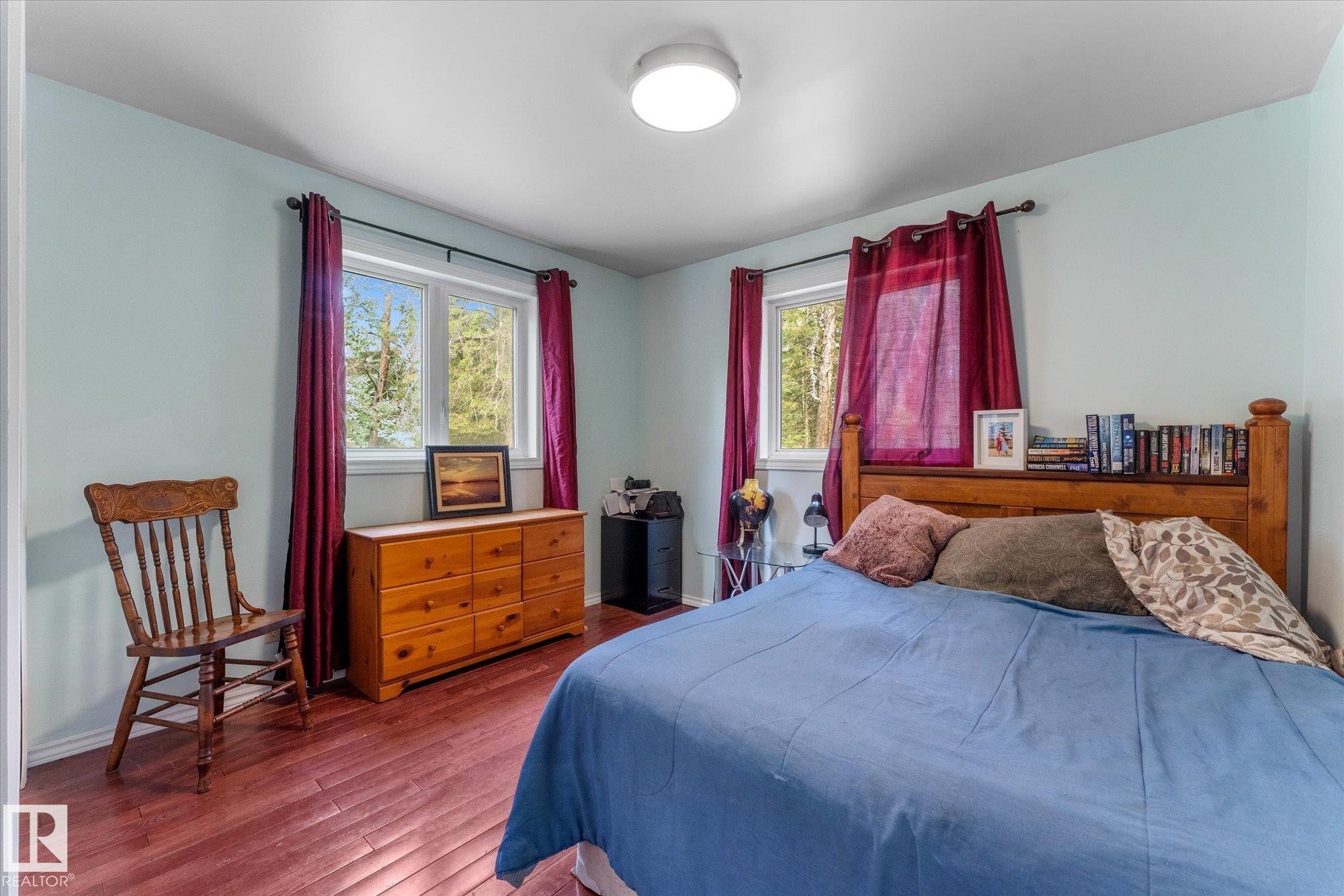 main floor bedroom could be converted to a flex space to suit your needs or office , the upper level has a large primary space - 2, 59031 Range Rd 232, Rural Thorhild County, AB - Indoor Photo Showing Bedroom