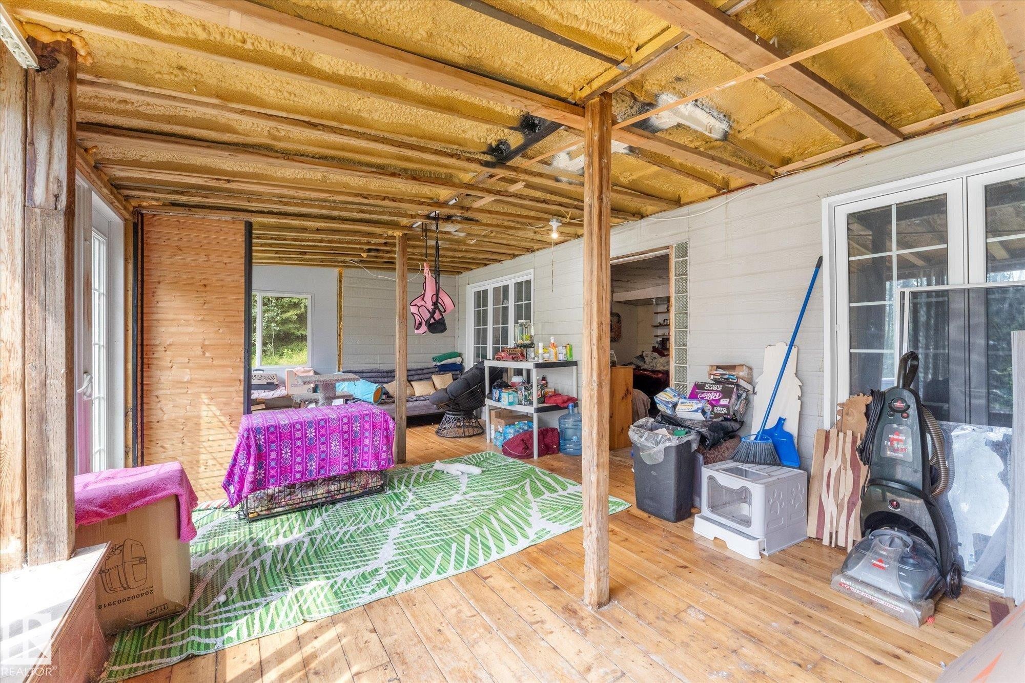 covered in area know as sun room that leads to the exterior of the lower level - 2, 59031 Range Rd 232, Rural Thorhild County, AB - With Deck Patio Veranda With Exterior