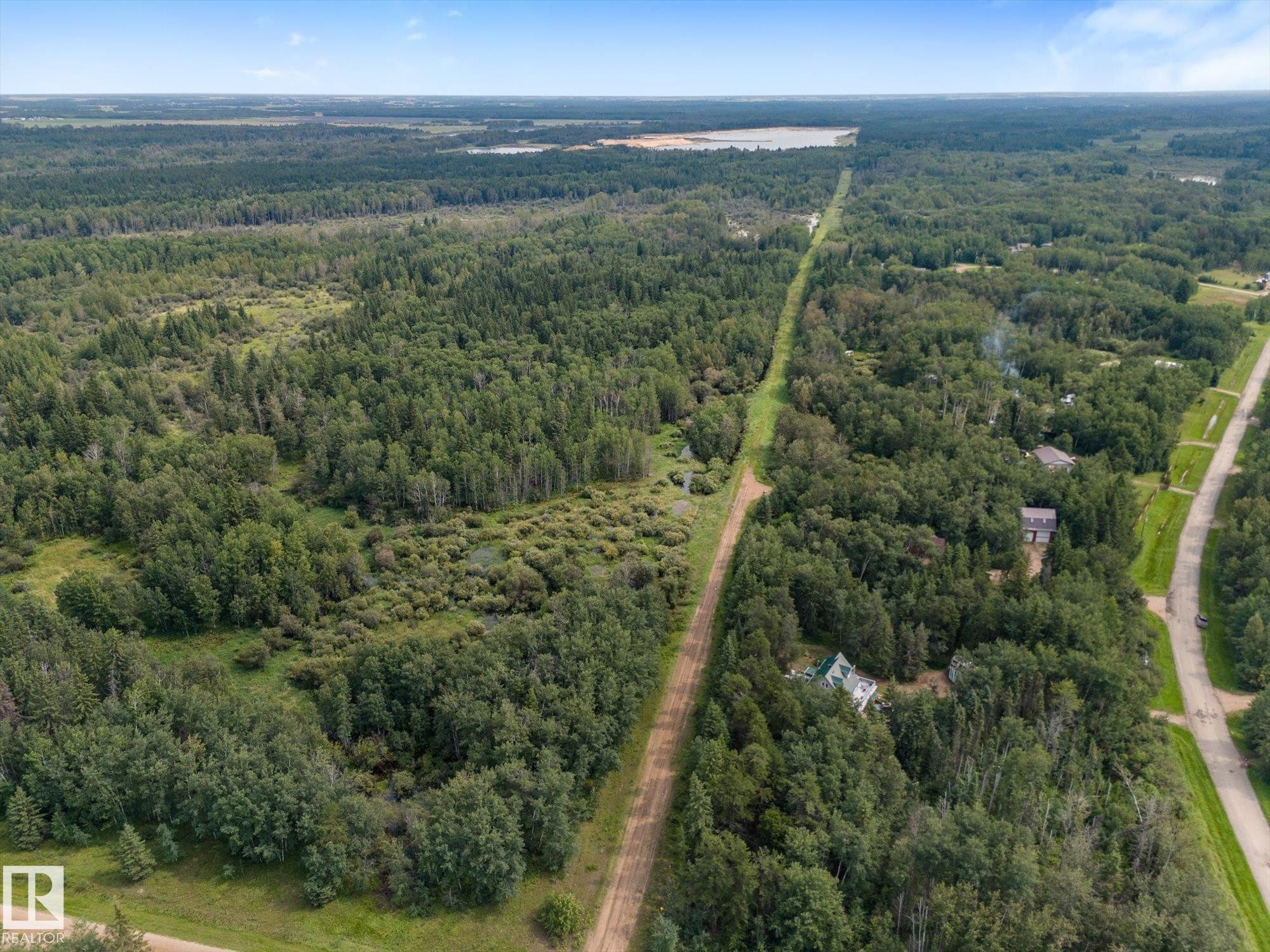 Expansive forested landscape featuring scattered residential structures and an unpaved road - 2, 59031 Range Rd 232, Rural Thorhild County, AB - Outdoor With View