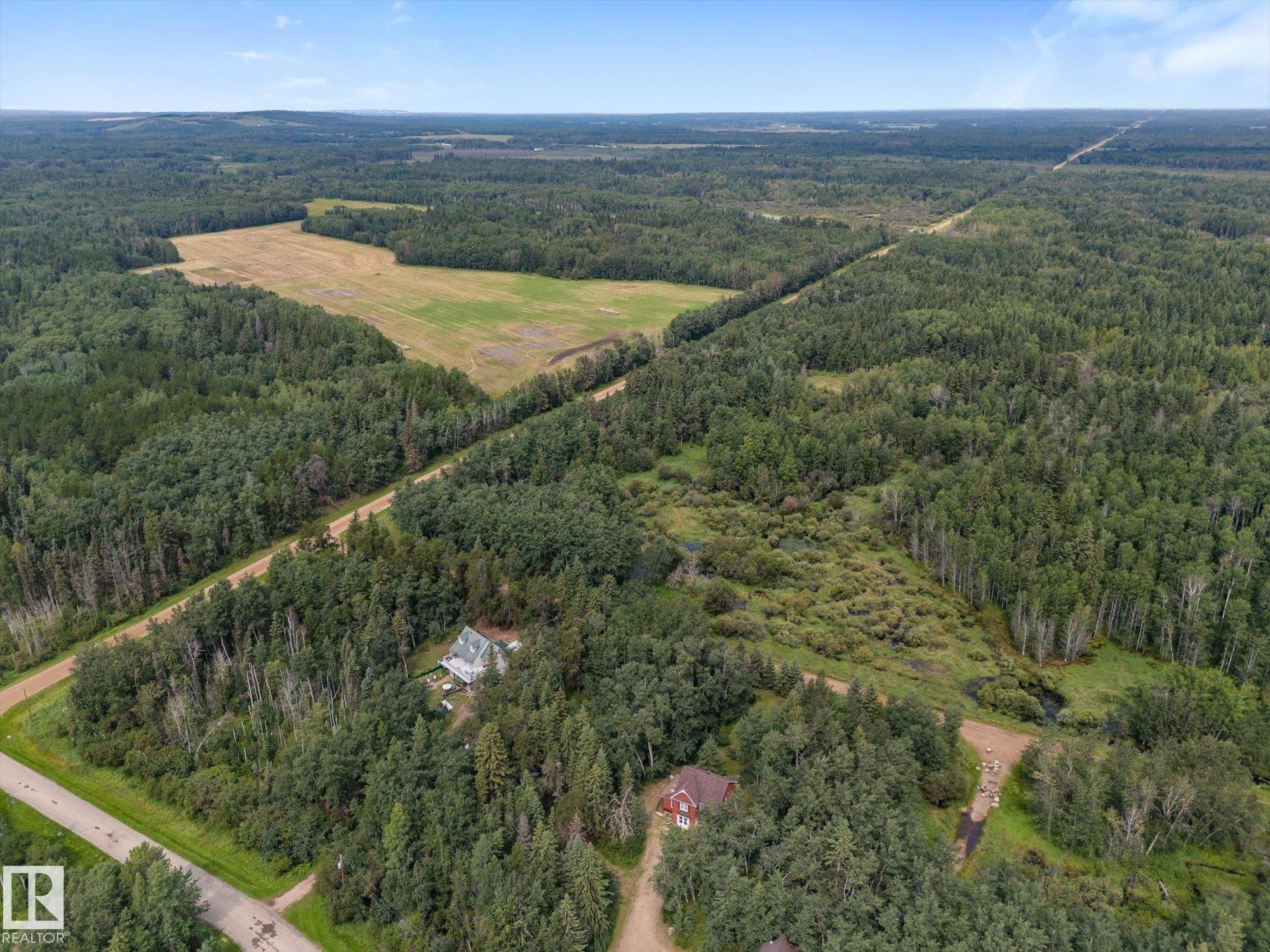 Expansive wooded parcel with a cleared field and established residences - 2, 59031 Range Rd 232, Rural Thorhild County, AB - Outdoor With View