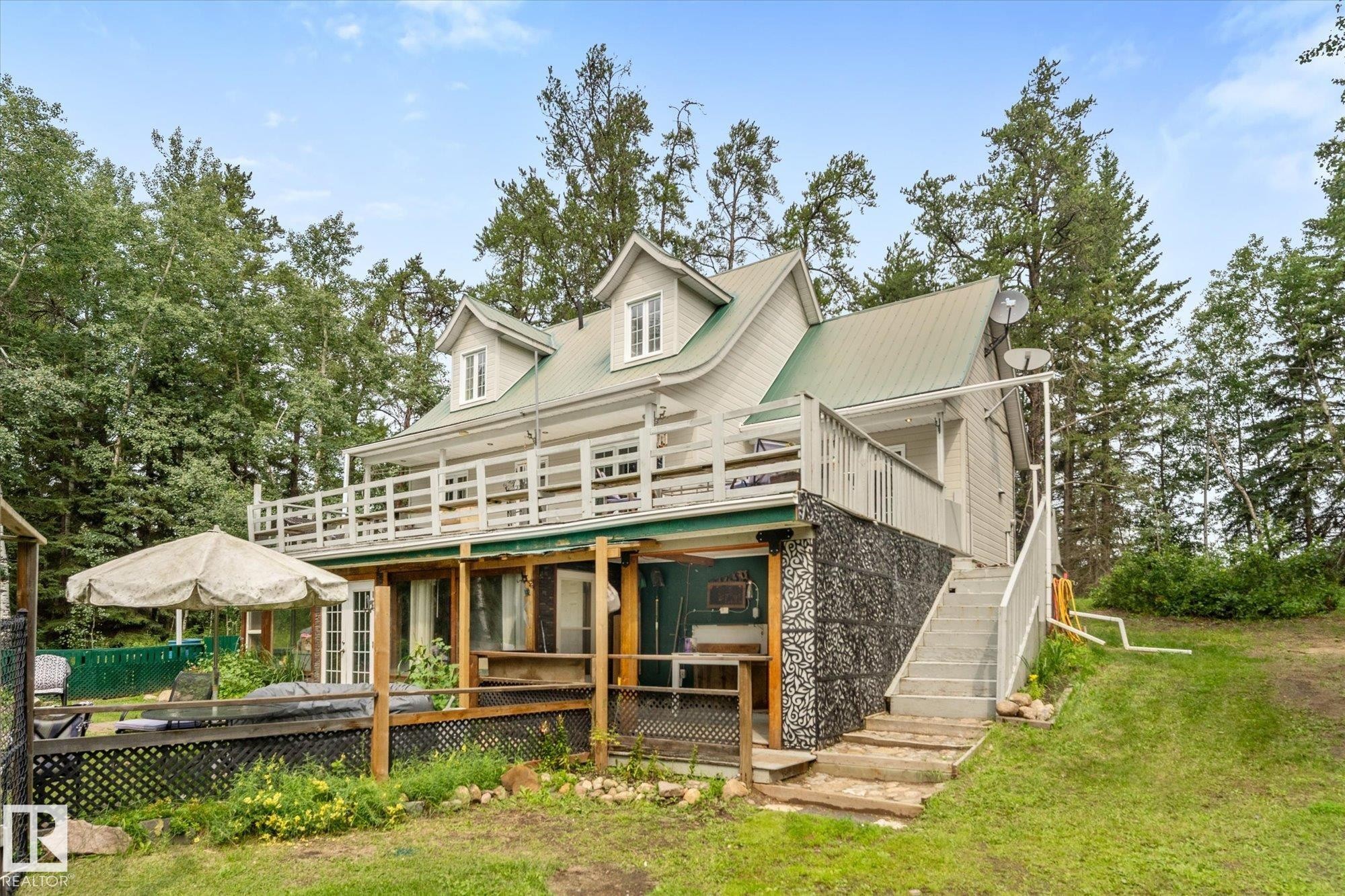 Conner lot south facing hill side home a sun room was added on by the owner not included in the sq footage - 2, 59031 Range Rd 232, Rural Thorhild County, AB - Outdoor With Deck Patio Veranda