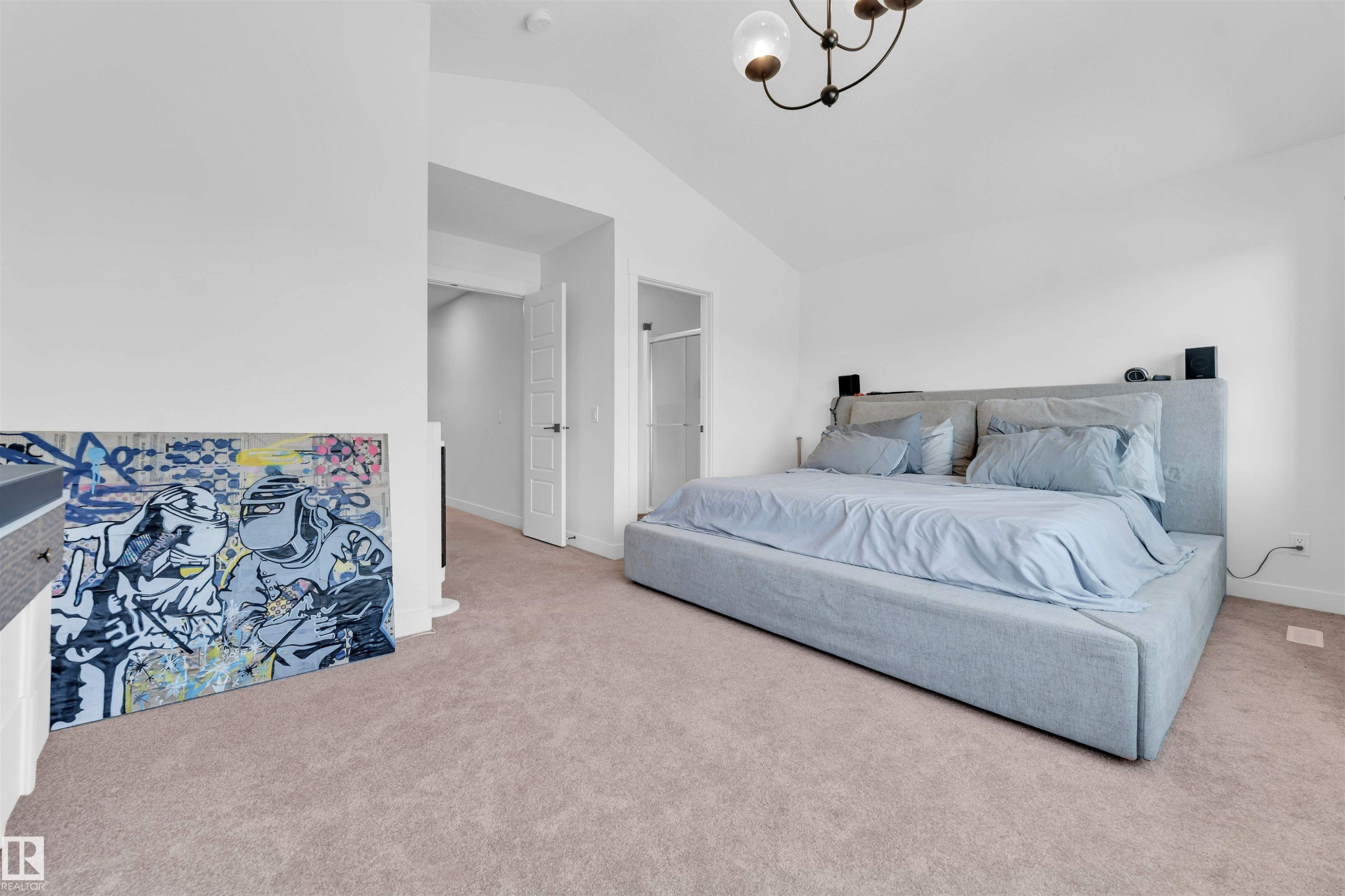 Vaulted ceiling with an attached chandelier, carpeted flooring, and white interior doors - 3236 Chernowski Way Sw, Edmonton, AB - Indoor Photo Showing Bedroom