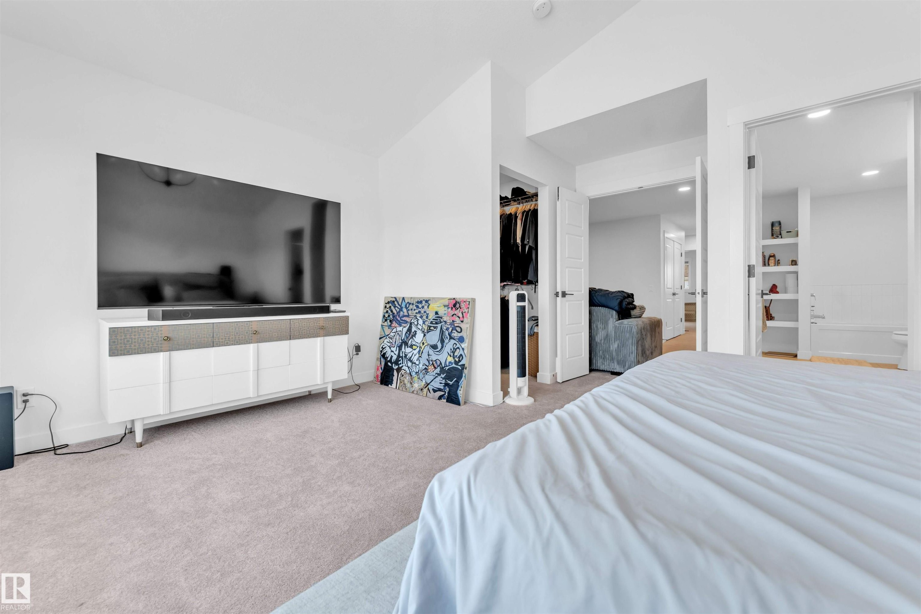 Neutral-toned carpeted flooring, white walls, recessed lighting, and open doorways to additional spaces - 3236 Chernowski Way Sw, Edmonton, AB - Indoor Photo Showing Bedroom