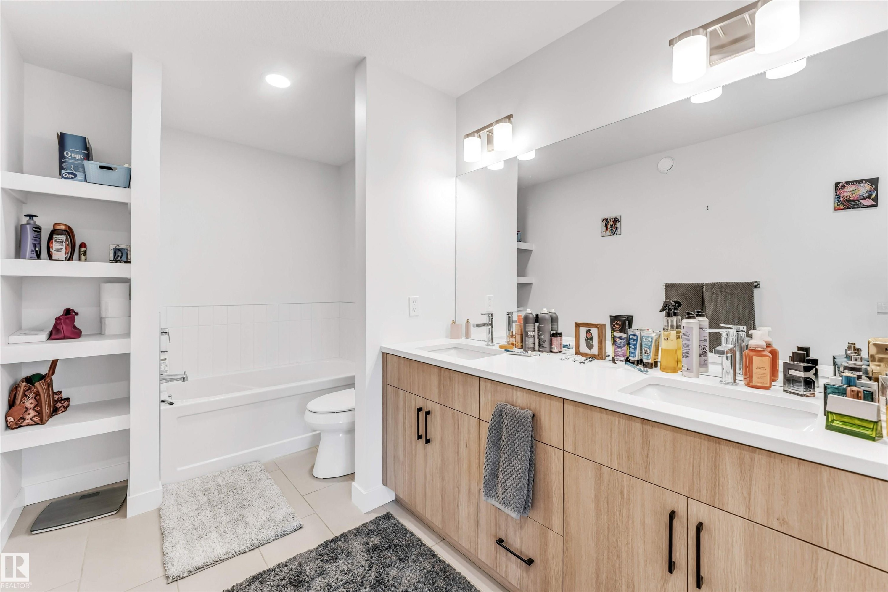 Dual vanity with integrated sinks and white countertops - 3236 Chernowski Way Sw, Edmonton, AB - Indoor Photo Showing Bathroom