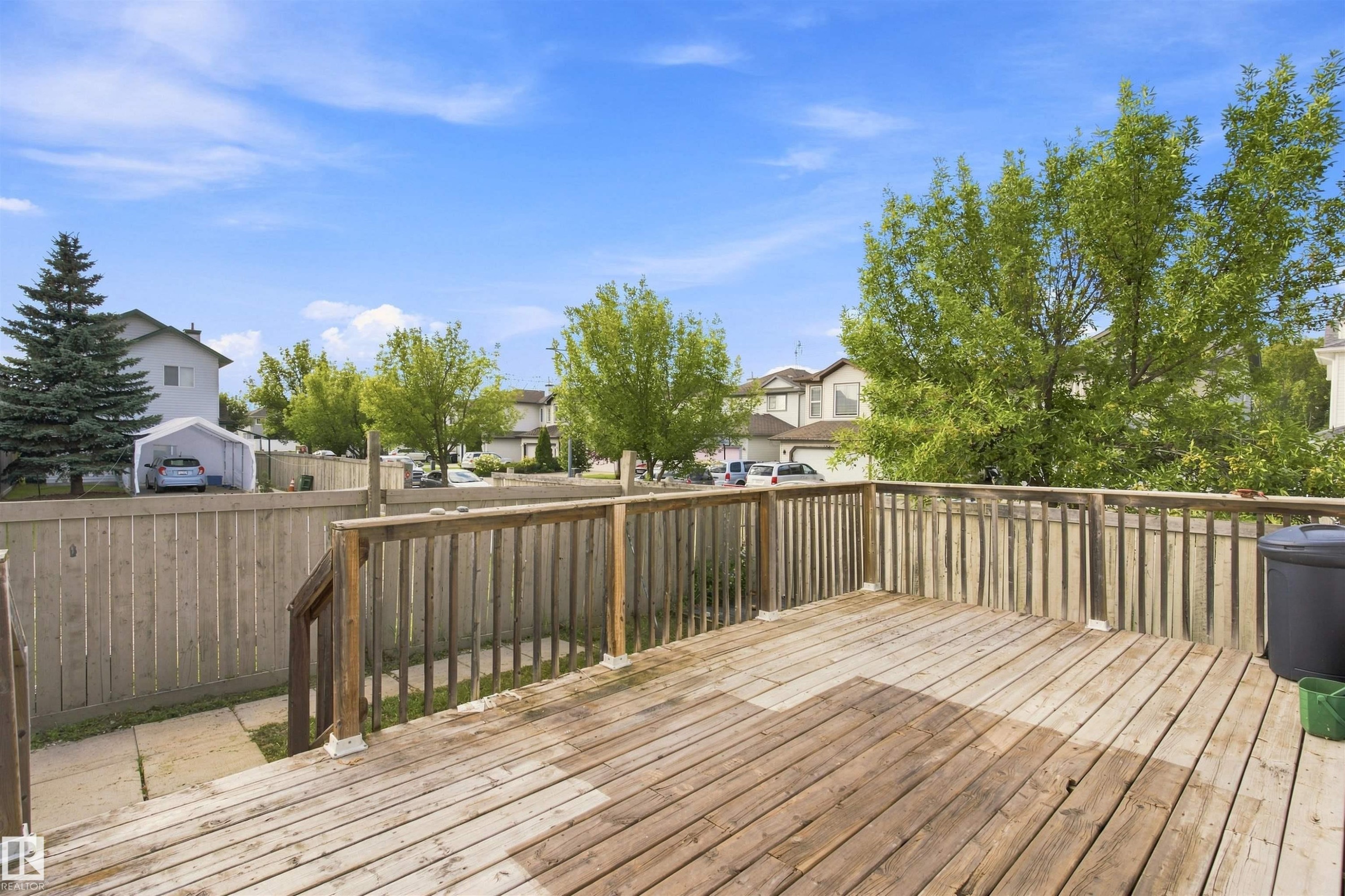 Wood-finish deck with railing and a perimeter fence - 204 84 Street Sw, Edmonton, AB - Outdoor With Deck Patio Veranda