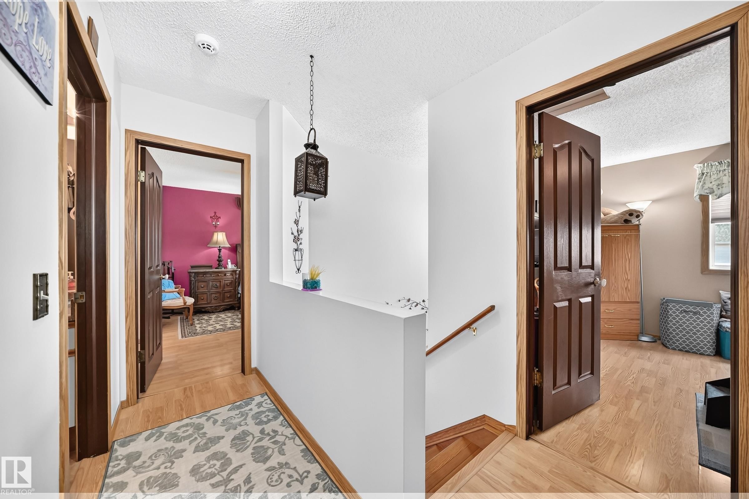 Wood-finish flooring with solid wood doors - 13069 37 Street Nw, Edmonton, AB - Indoor Photo Showing Other Room