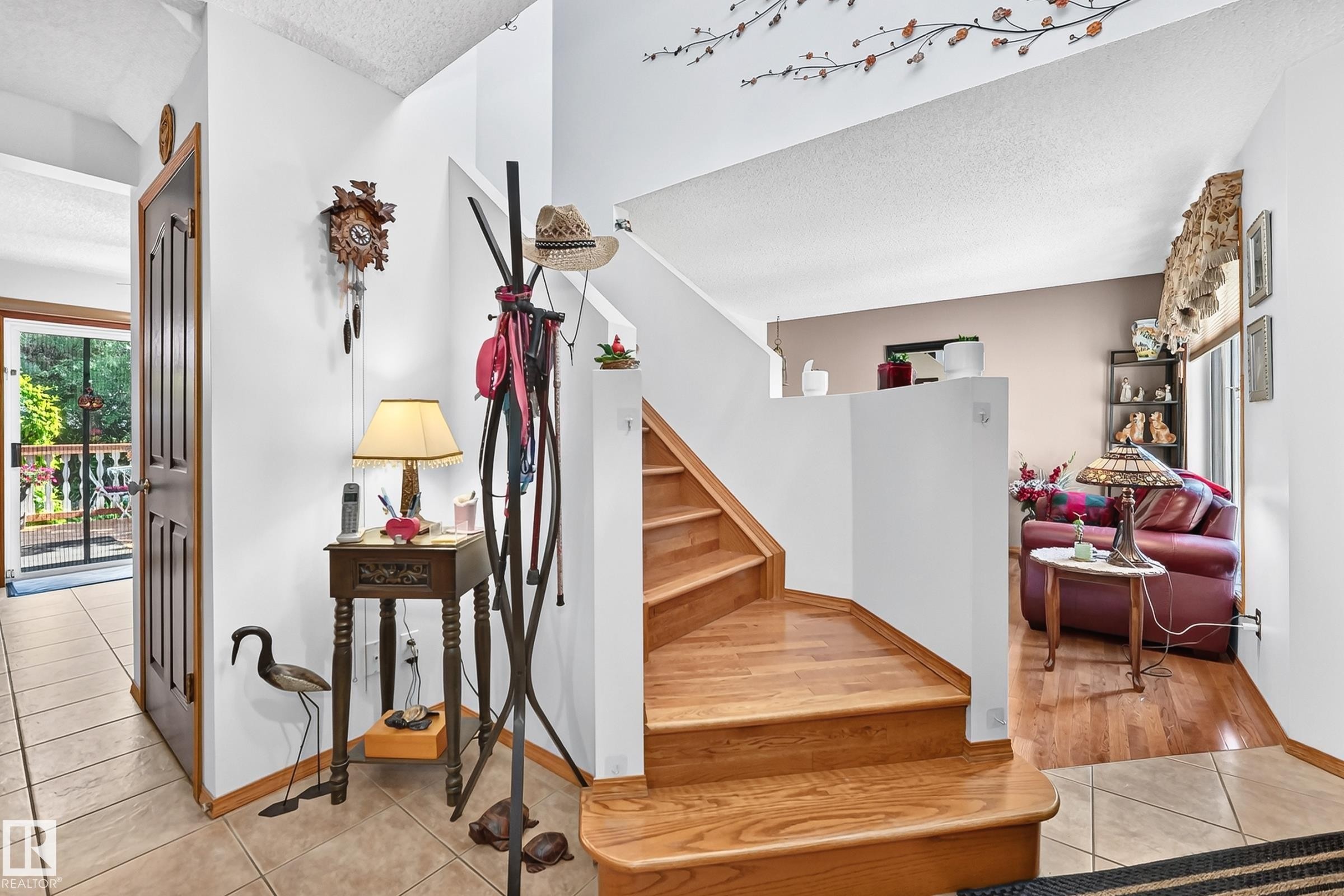 Wood-finish staircase, tile flooring, wood-finish flooring, and a multi-pane glass door - 13069 37 Street Nw, Edmonton, AB - Indoor Photo Showing Other Room