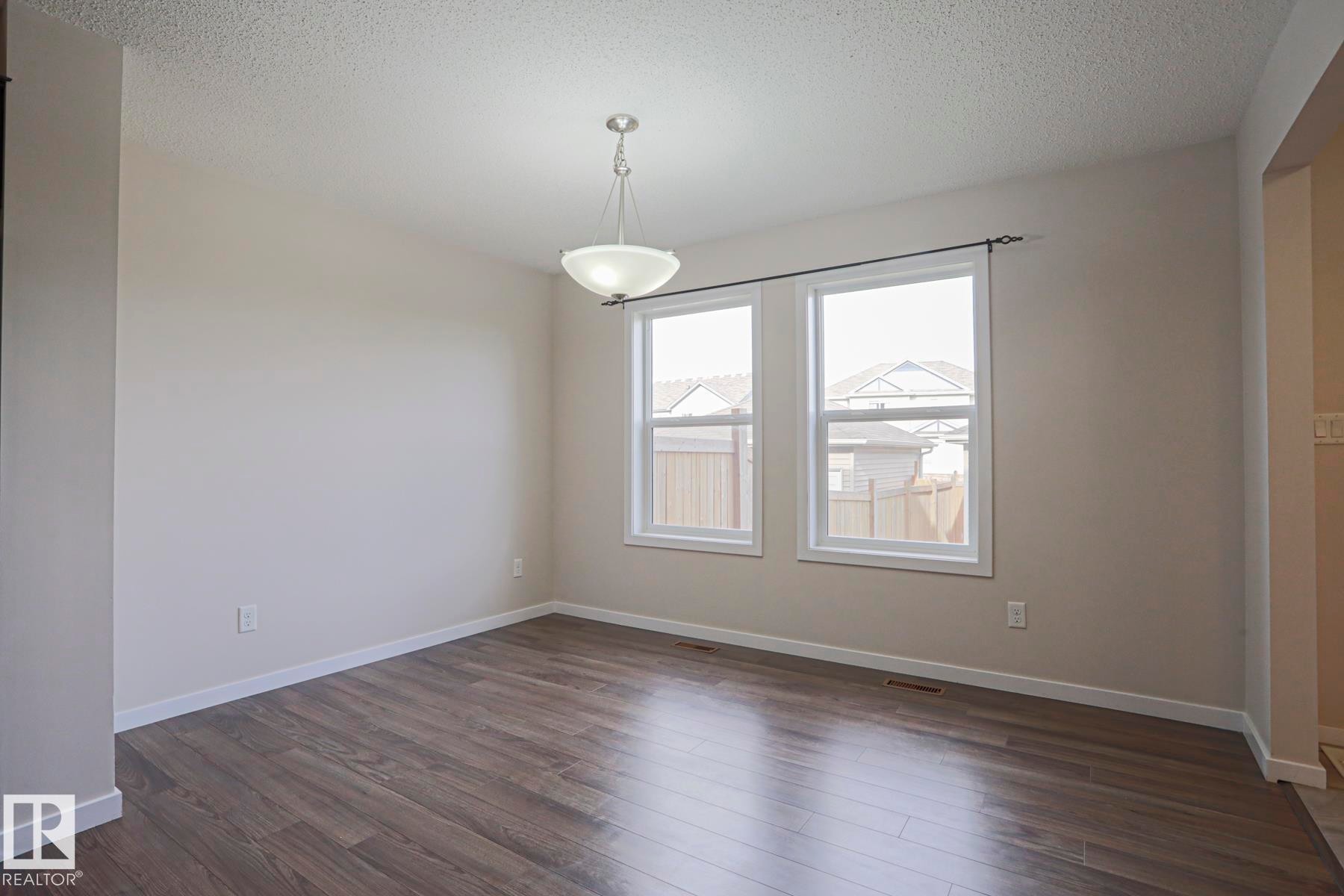 Room featuring wood-finish flooring, white trim, and a semi-flush mount ceiling light - 308 Watt Boulevard Sw, Edmonton, AB - Indoor Photo Showing Other Room