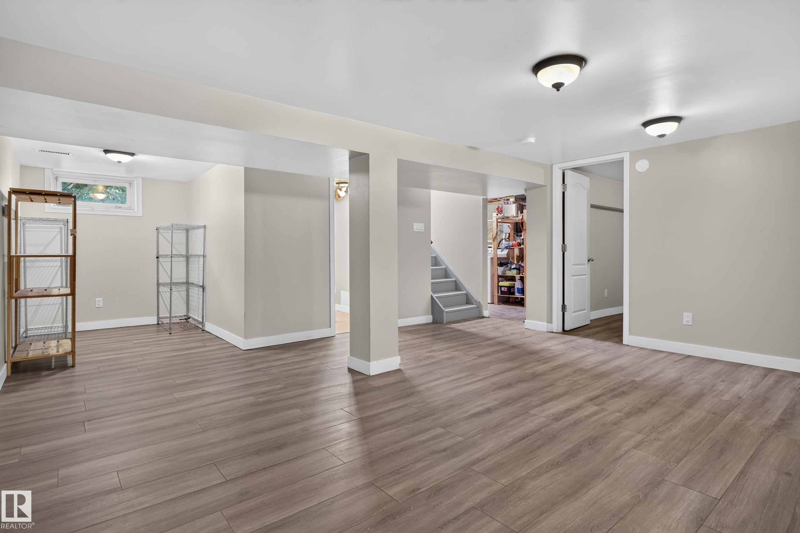 Spacious room featuring wood-finish flooring, recessed lighting, and neutral wall tones - 11549 88 Street Nw, Edmonton, AB - Indoor