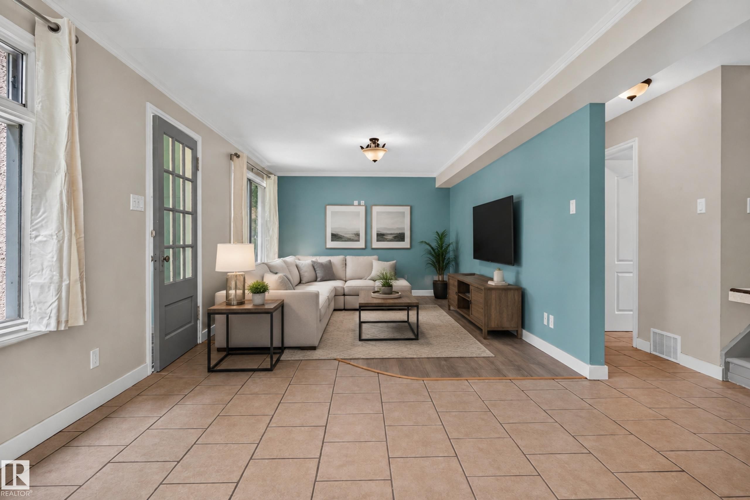 Porcelain tile flooring throughout, wood-finish flooring in the living area, and a partial accent wall - 11549 88 Street Nw, Edmonton, AB - Indoor