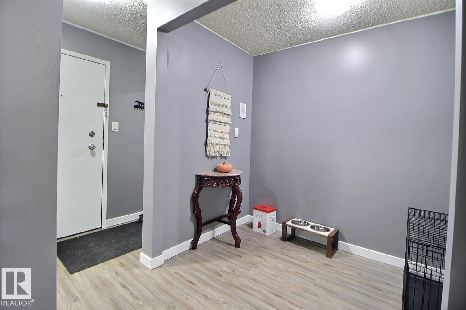 Wood-finish flooring with white trim and a neutral paint palette - #304 14004 26 St Nw, Edmonton, AB - Indoor