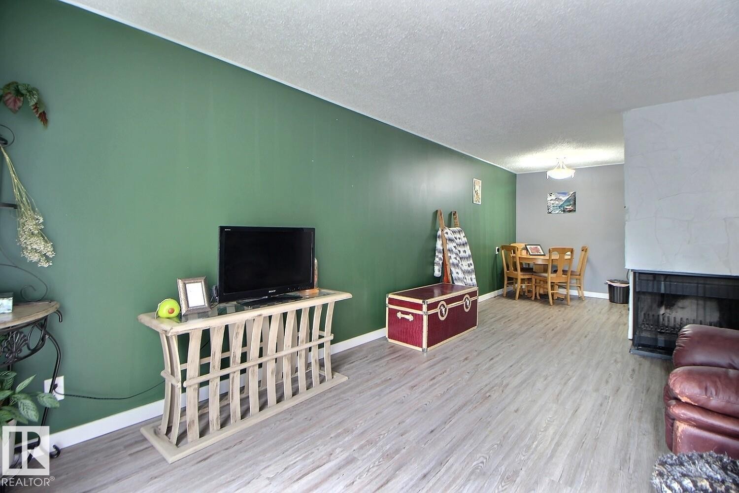 Light wood-finish flooring complements the interior wall colors - #304 14004 26 St Nw, Edmonton, AB - Indoor