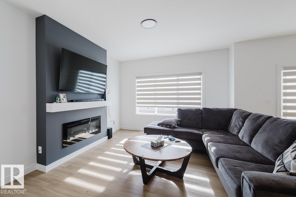 6411 27 Avenue Sw, Edmonton, AB - Indoor Photo Showing Living Room With Fireplace