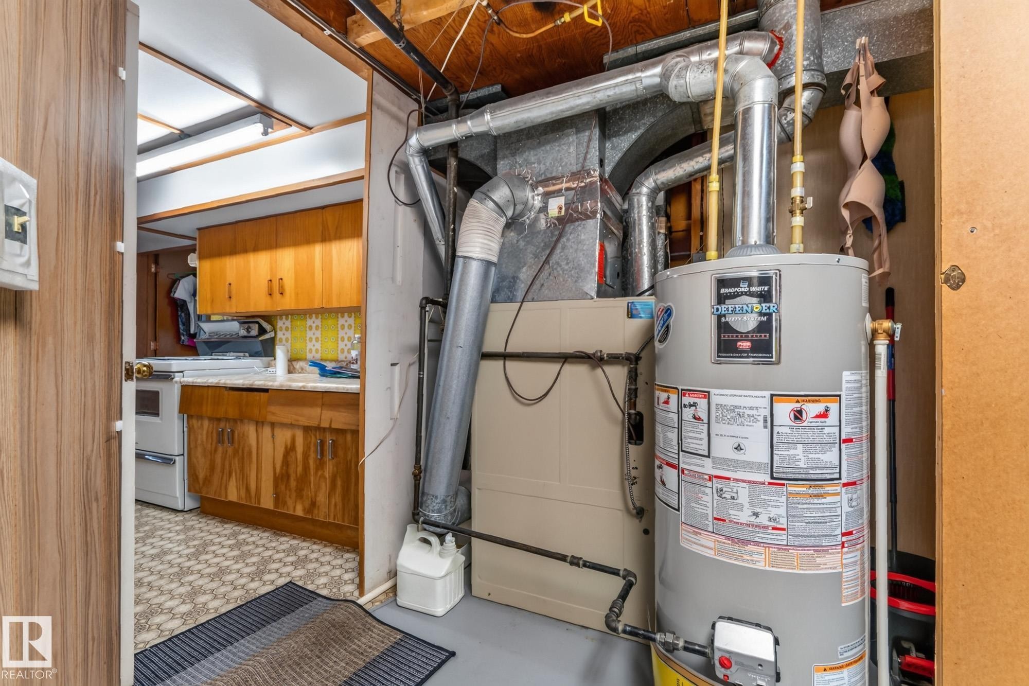 Utility area featuring a water heater and furnace unit - 13432 134 Street Nw, Edmonton, AB - Indoor Photo Showing Basement