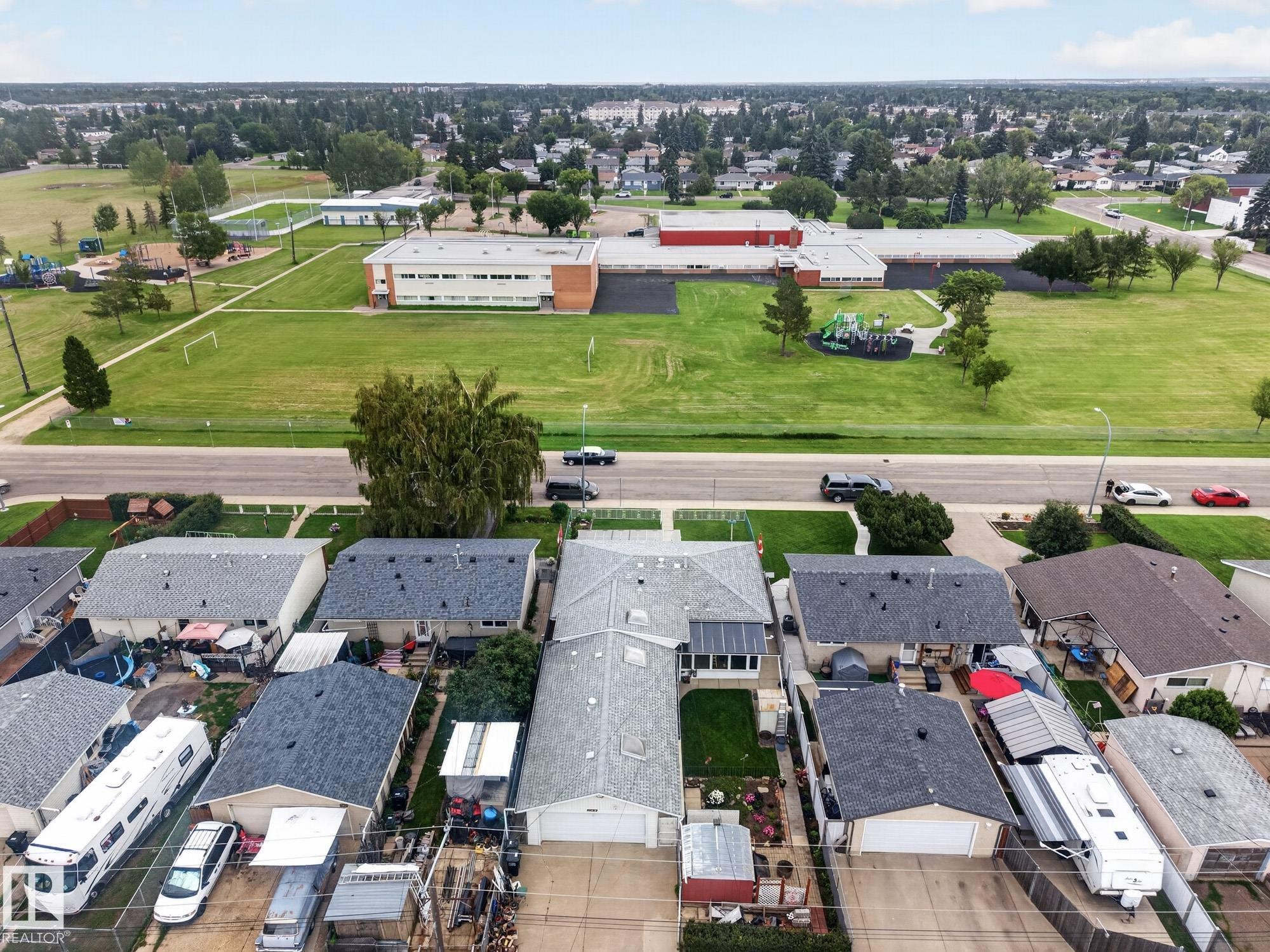 Aerial community overview featuring residential properties and institutional buildings - 13432 134 Street Nw, Edmonton, AB - Outdoor With View