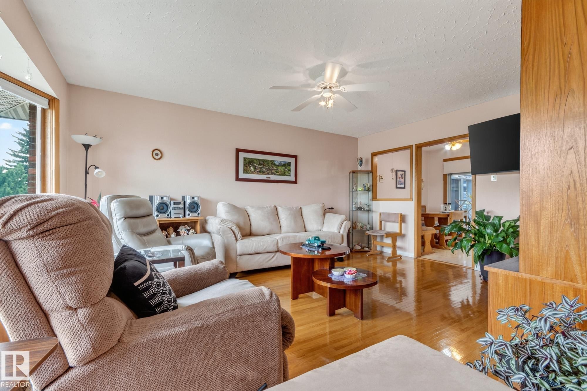 Hardwood flooring, ceiling fan, and framed doorways - 13432 134 Street Nw, Edmonton, AB - Indoor Photo Showing Living Room