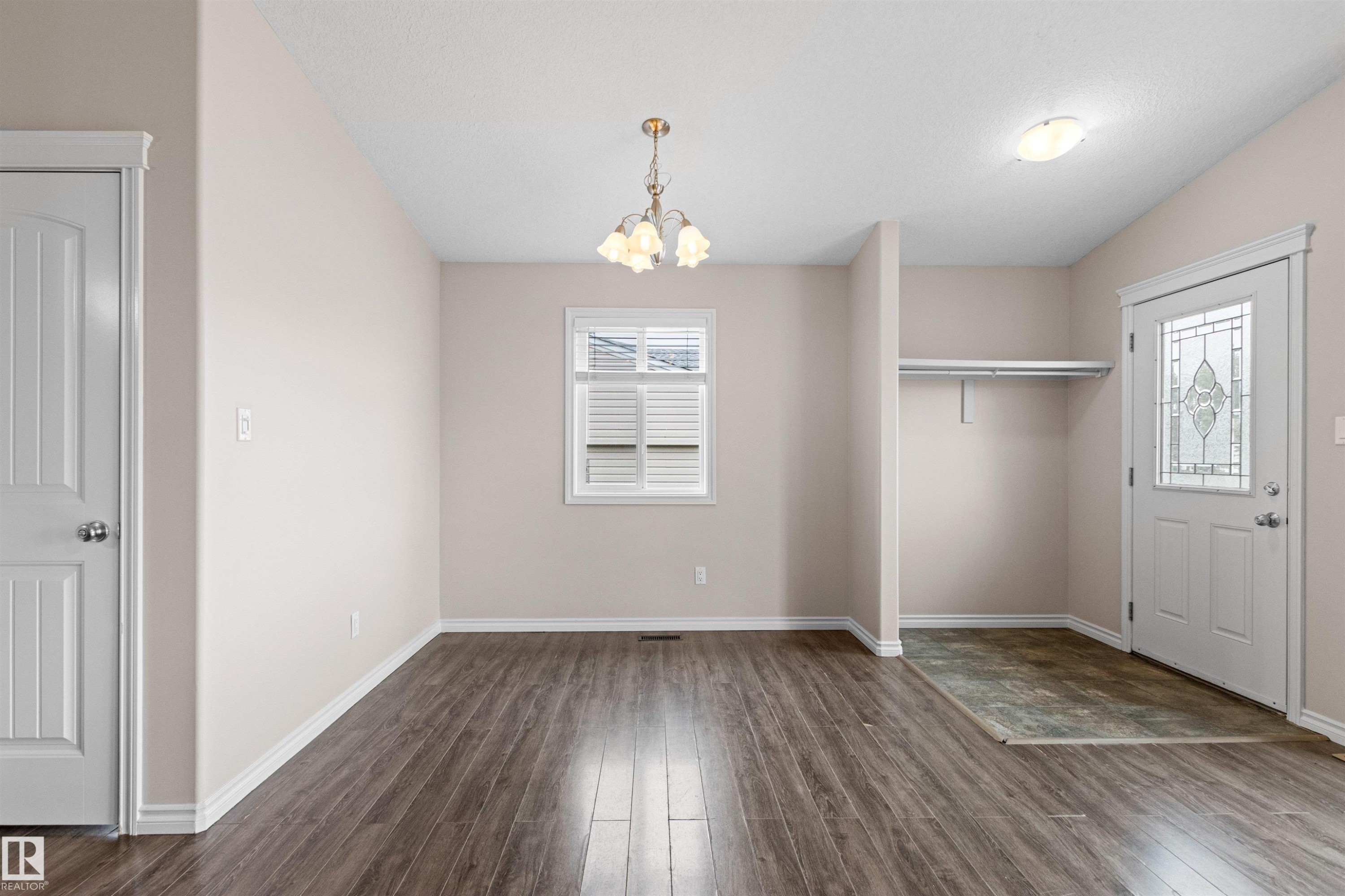 Light-filled interior featuring wood-finish flooring, neutral wall tones, and white trim - 10634 155 Street Nw, Edmonton, AB - Indoor Photo Showing Other Room