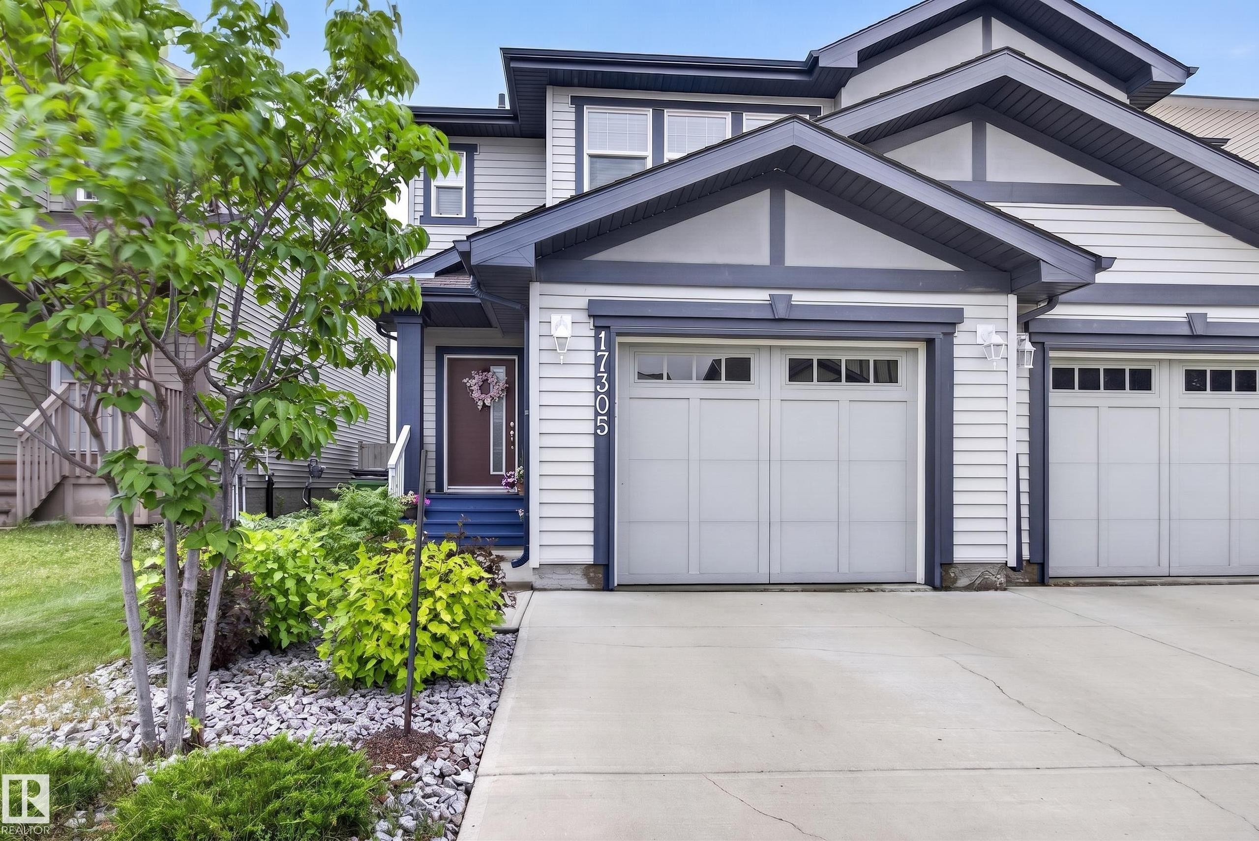 Contemporary multi-level exterior featuring light-toned siding and dark trim accents - 17305 73 Street Nw, Edmonton, AB - Outdoor