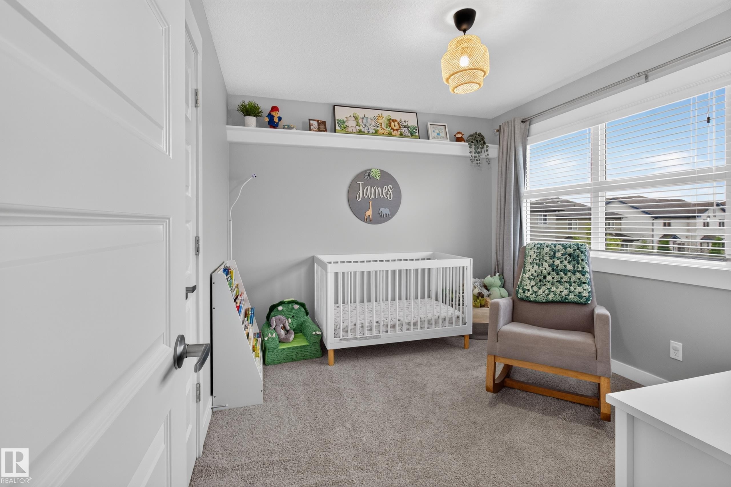 Bright interior space featuring a window with horizontal blinds and drapery, neutral carpet flooring, and a ceiling-mounted light fixture - 17305 73 Street Nw, Edmonton, AB - Indoor Photo Showing Bedroom