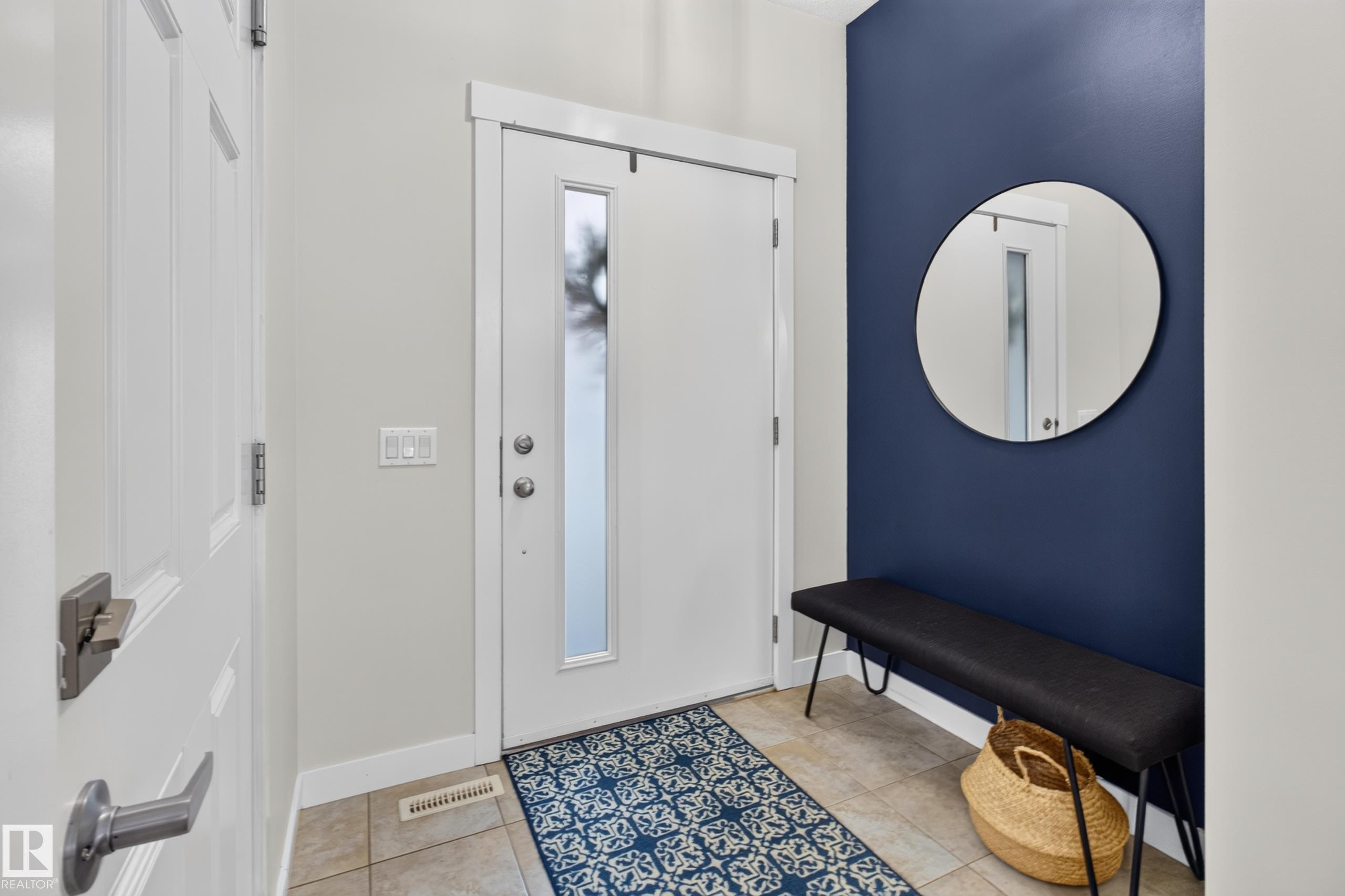 Entryway featuring a contemporary front door with a vertical frosted glass pane, tile flooring, and a contrasting accent wall - 17305 73 Street Nw, Edmonton, AB - Indoor Photo Showing Other Room