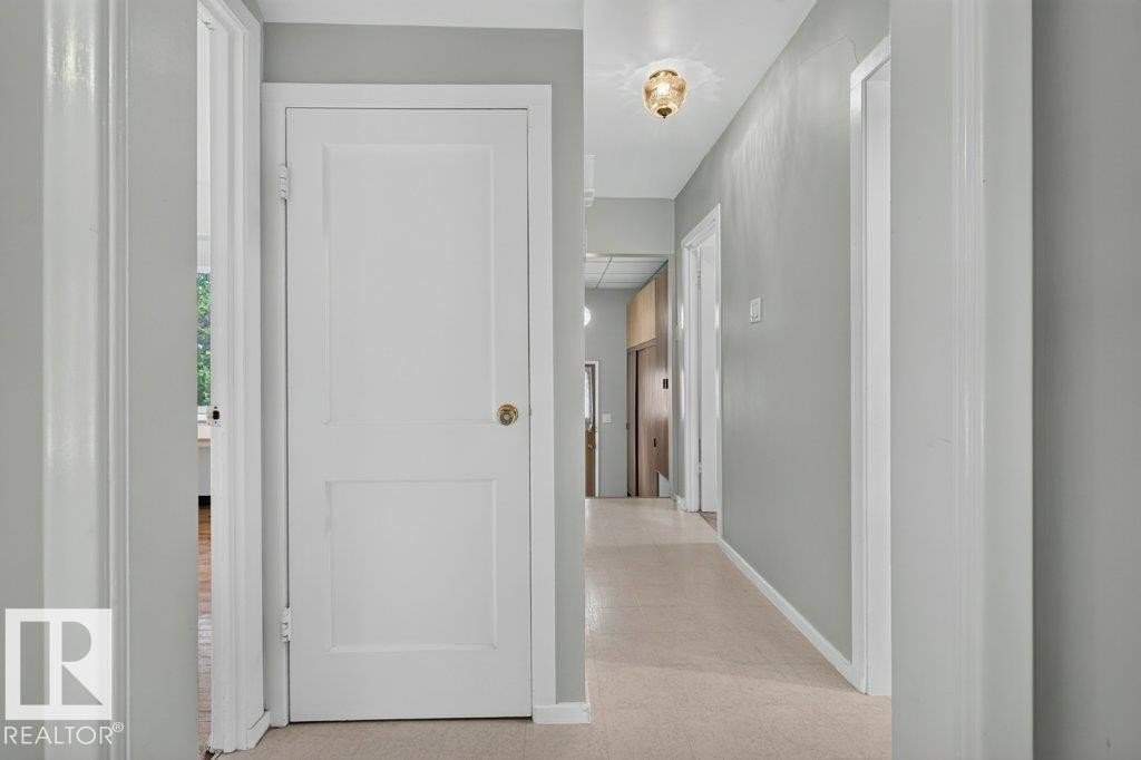 Hallway with light gray walls, white trim, and a flush mount ceiling fixture - 9026 92 Street Nw, Edmonton, AB - Indoor Photo Showing Other Room