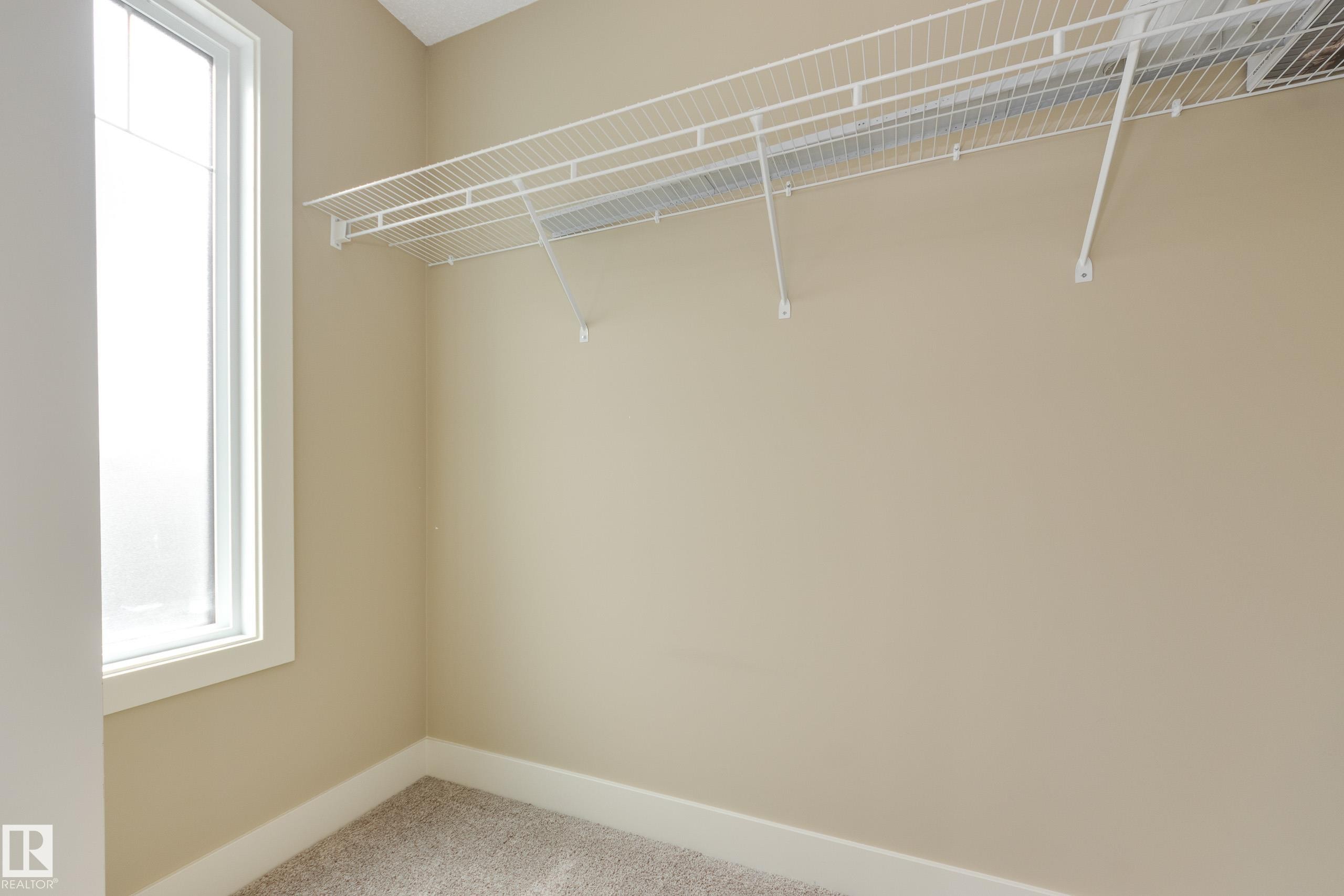 Walk-in closet with window - #39 804 Welsh Dr Sw, Edmonton, AB - Indoor With Storage