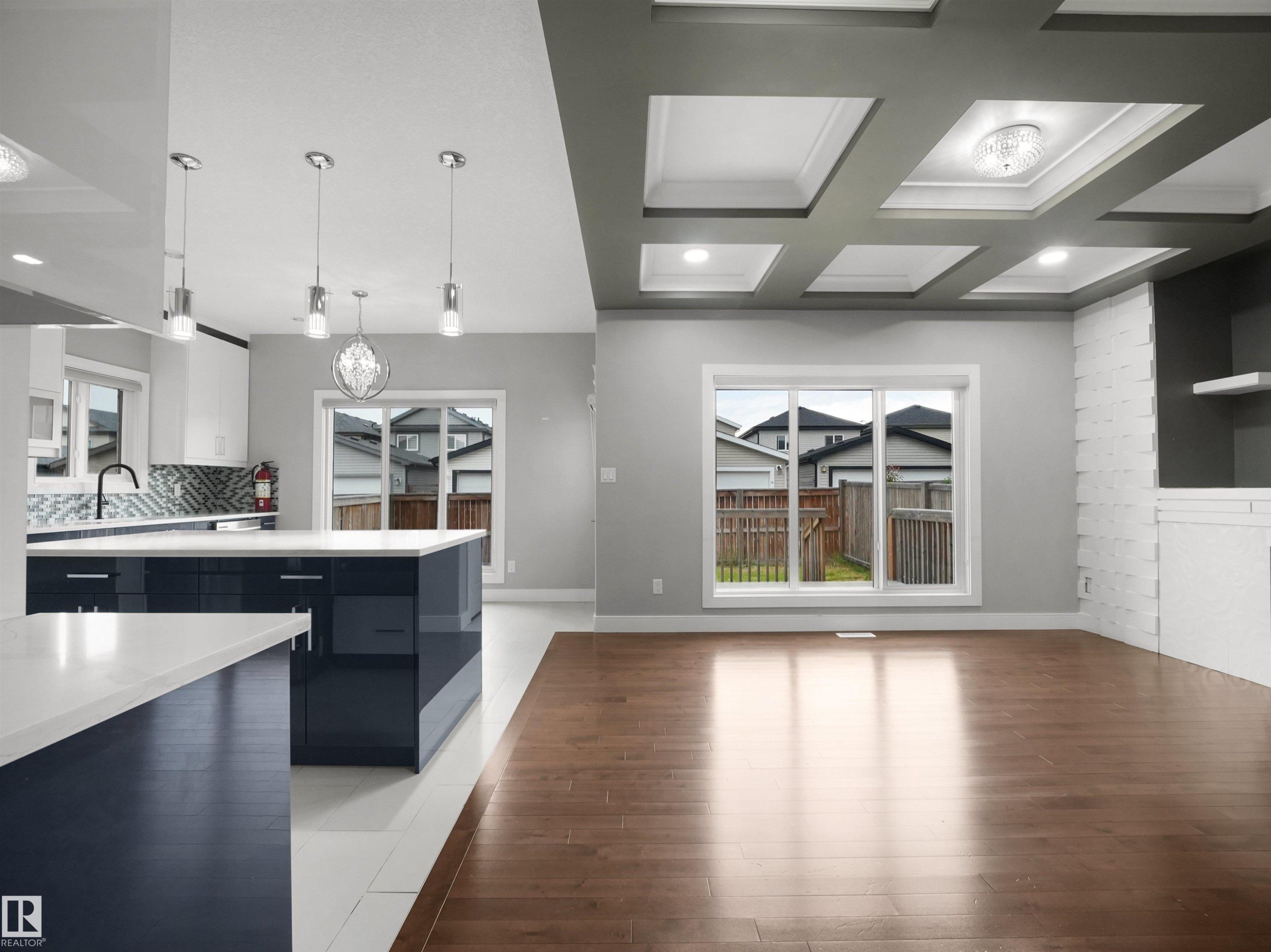 Open-concept living space with hardwood flooring and a coffered ceiling - 17020 62 Street Nw, Edmonton, AB - Indoor Photo Showing Kitchen With Double Sink With Upgraded Kitchen