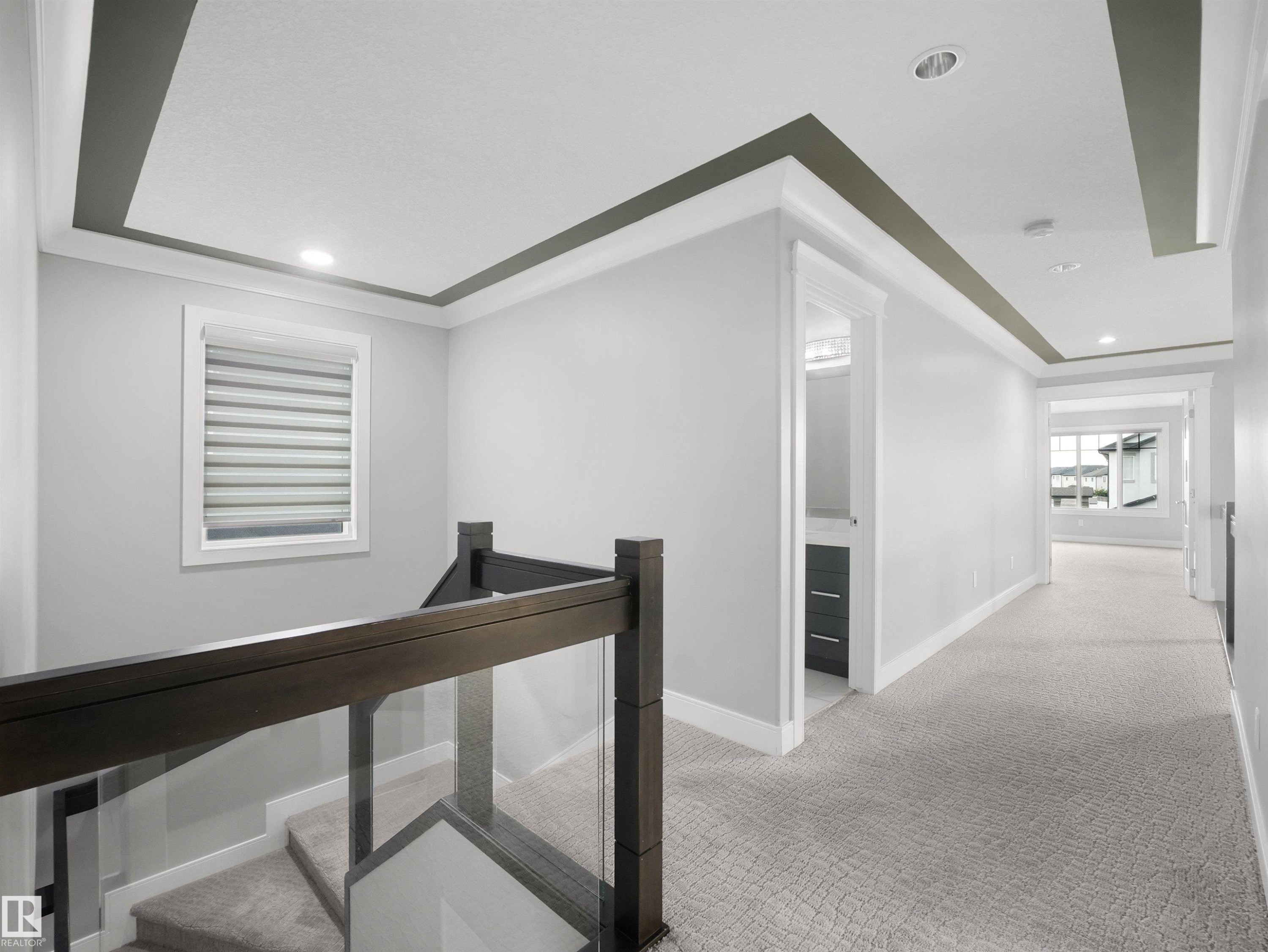 Upper hallway featuring recessed lighting, tray ceiling, and carpet flooring - 17020 62 Street Nw, Edmonton, AB - Indoor Photo Showing Other Room