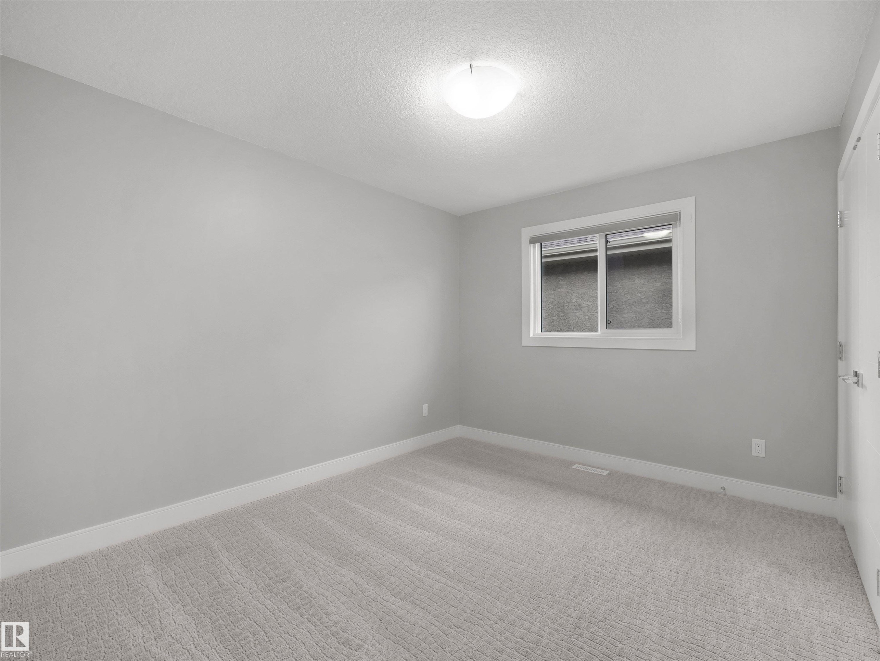 Neutral-toned wall finish, wall-to-wall carpeting, and a flush mount ceiling light fixture - 17020 62 Street Nw, Edmonton, AB - Indoor Photo Showing Other Room
