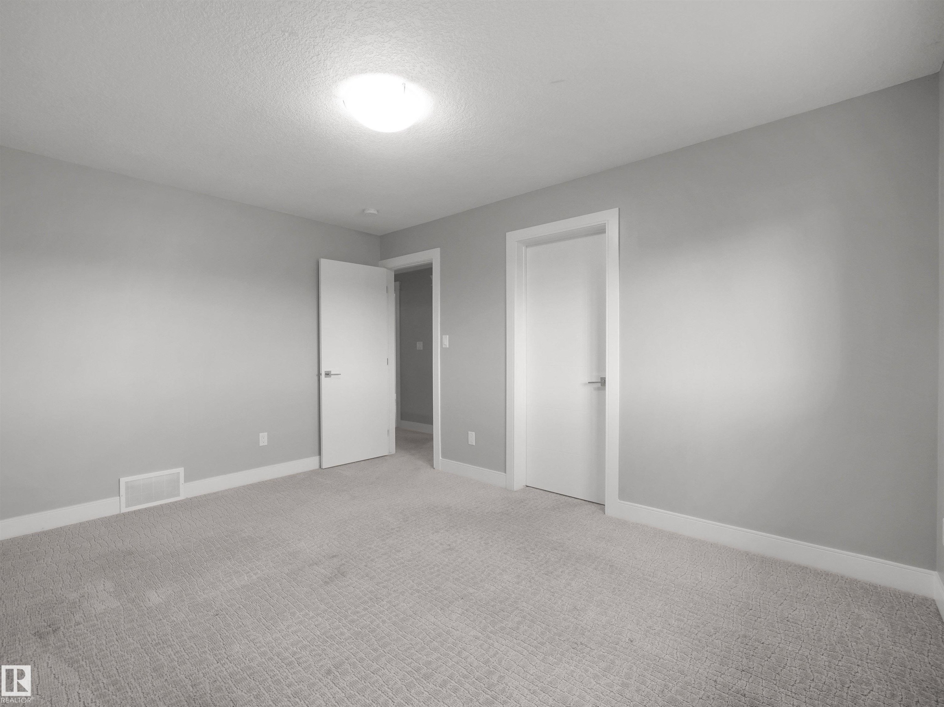 Plush carpeting, light gray wall paint, and white trim - 17020 62 Street Nw, Edmonton, AB - Indoor Photo Showing Other Room