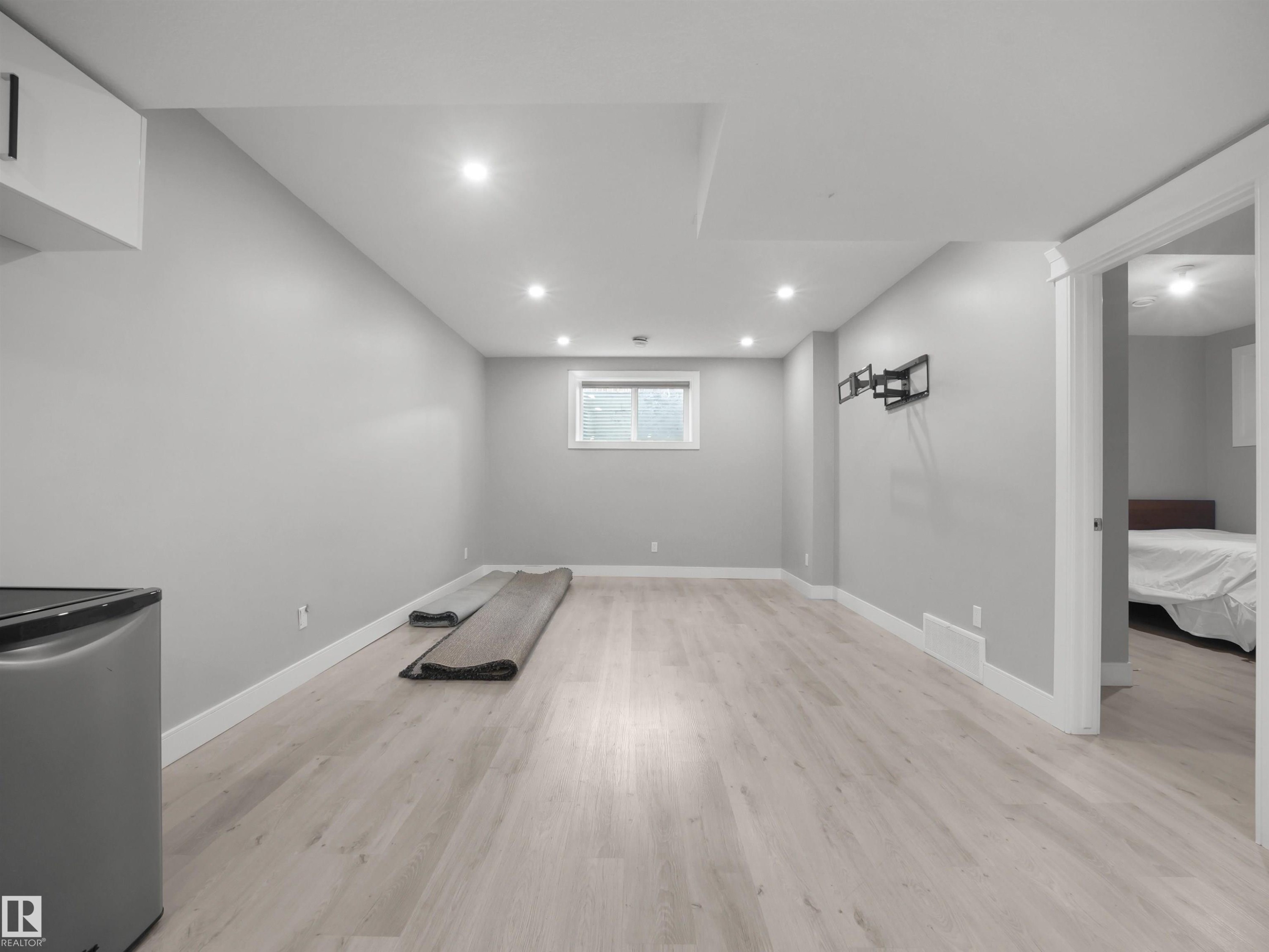 Recessed ceiling lighting, light wood-finish flooring, and a window providing natural illumination - 17020 62 Street Nw, Edmonton, AB - Indoor