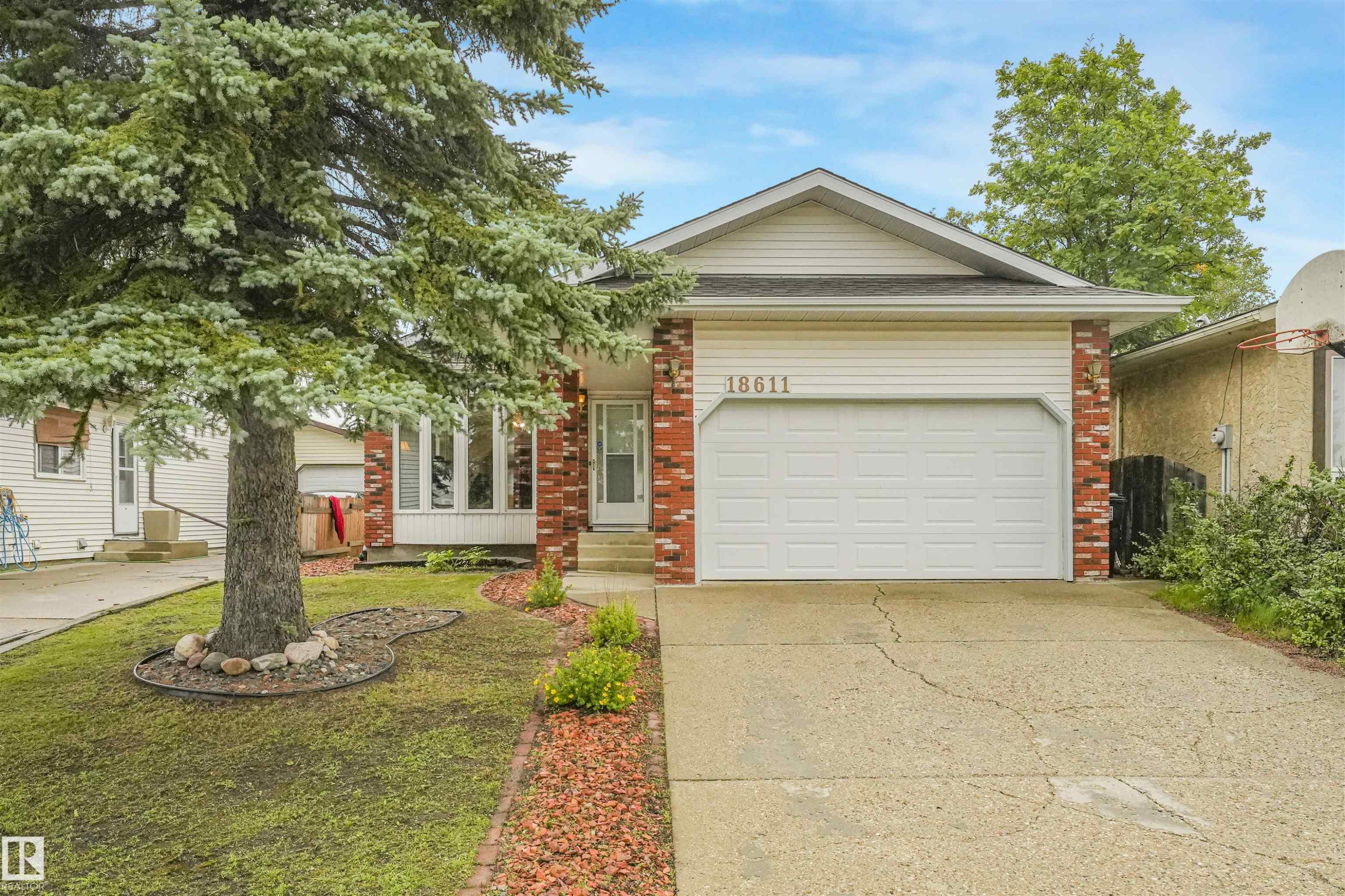 Front exterior with white siding and brick accents - 18611 57 Avenue Nw, Edmonton, AB - Outdoor With Facade