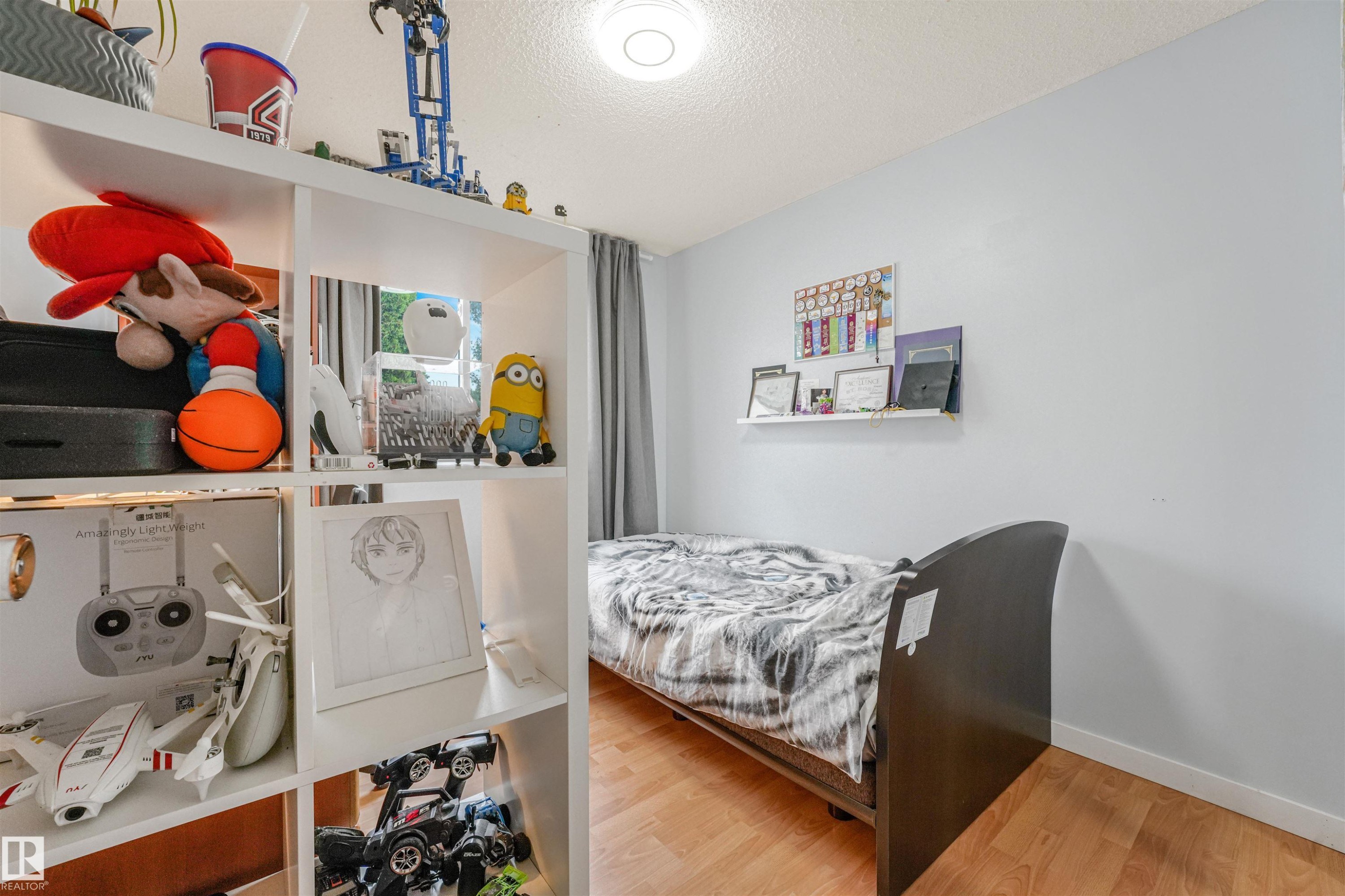Light wood-finish flooring complements the neutral wall color - 18611 57 Avenue Nw, Edmonton, AB - Indoor Photo Showing Bedroom