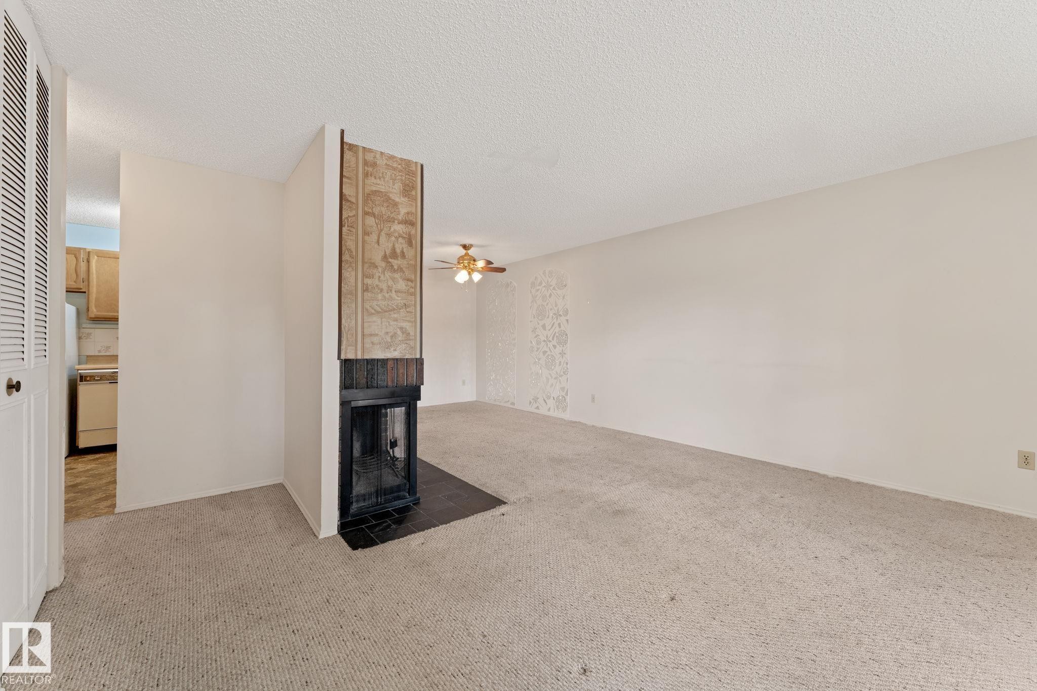 164 Surrey Gardens Nw, Edmonton, AB - Indoor Photo Showing Other Room With Fireplace