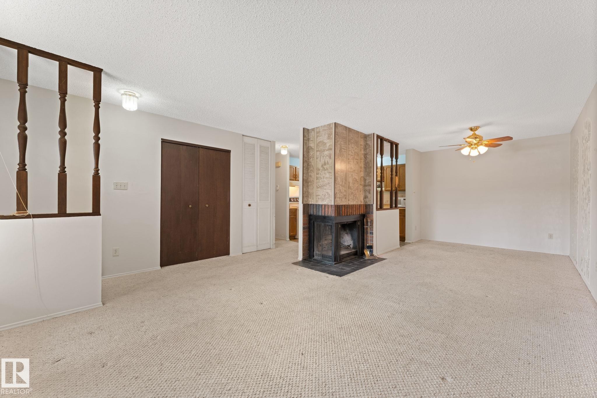 164 Surrey Gardens Nw, Edmonton, AB - Indoor Photo Showing Other Room With Fireplace