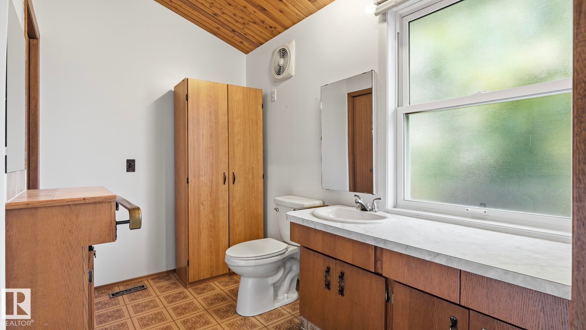 White walls with an angled wood-paneled ceiling - 8408 176 Street Nw, Edmonton, AB - Indoor Photo Showing Bathroom
