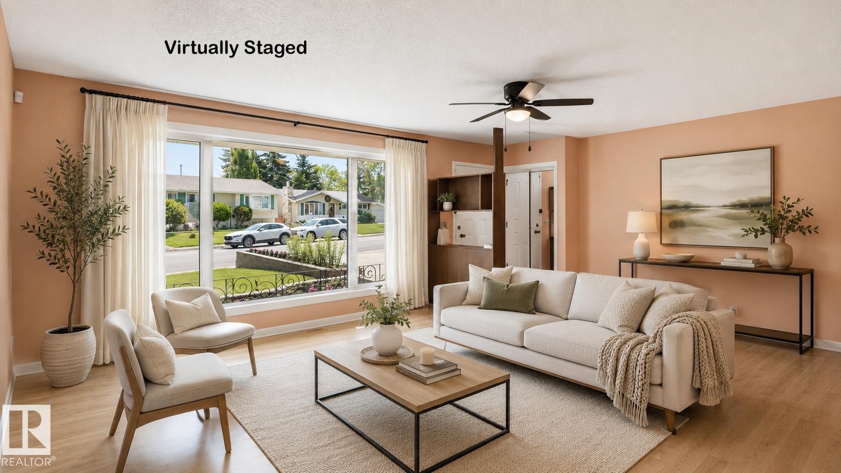 Spacious living area featuring large picture windows, wood-finish flooring, and a ceiling fan - 8408 176 Street Nw, Edmonton, AB - Indoor Photo Showing Living Room
