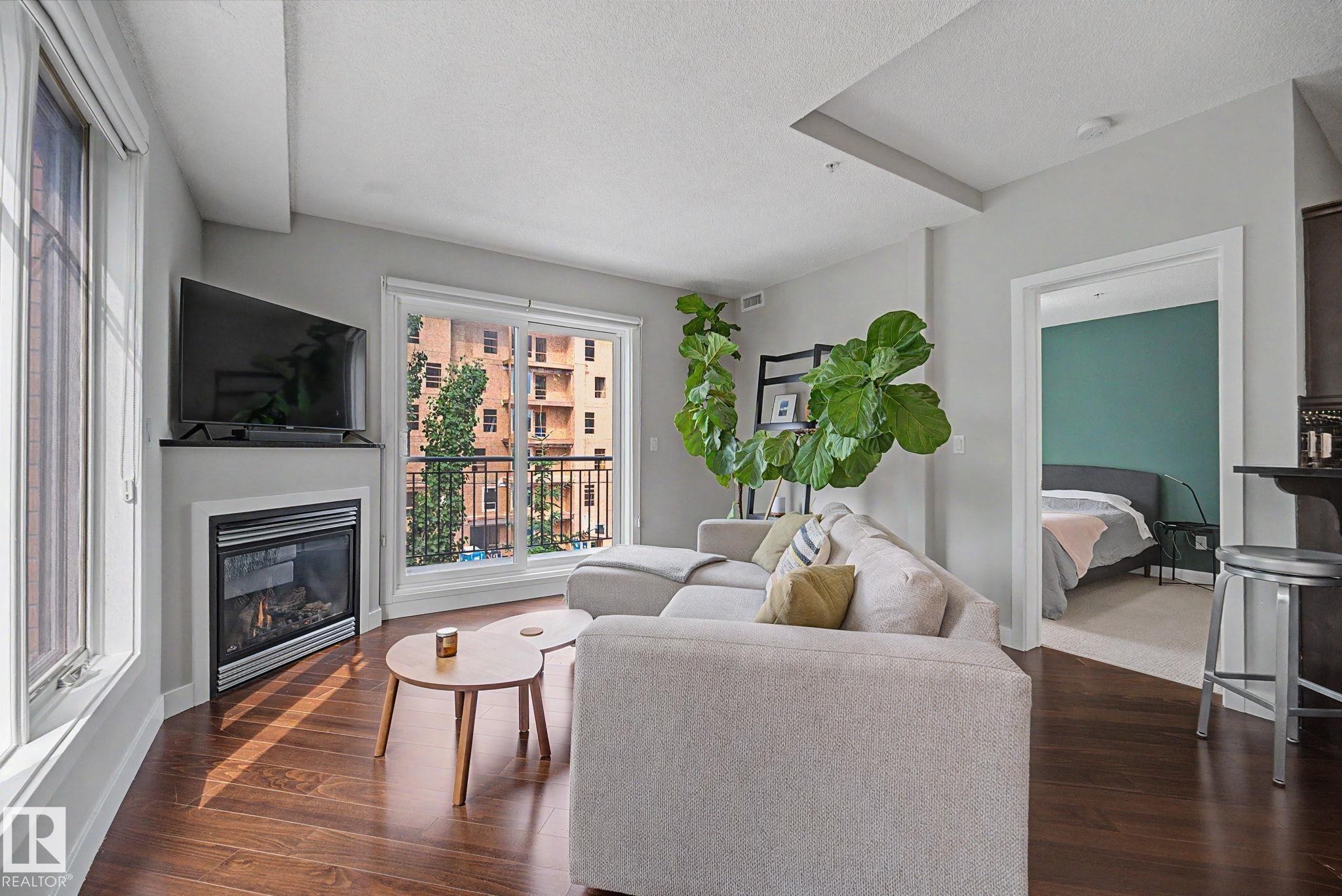 #307 7907 109 St Nw, Edmonton, AB - Indoor Photo Showing Living Room With Fireplace